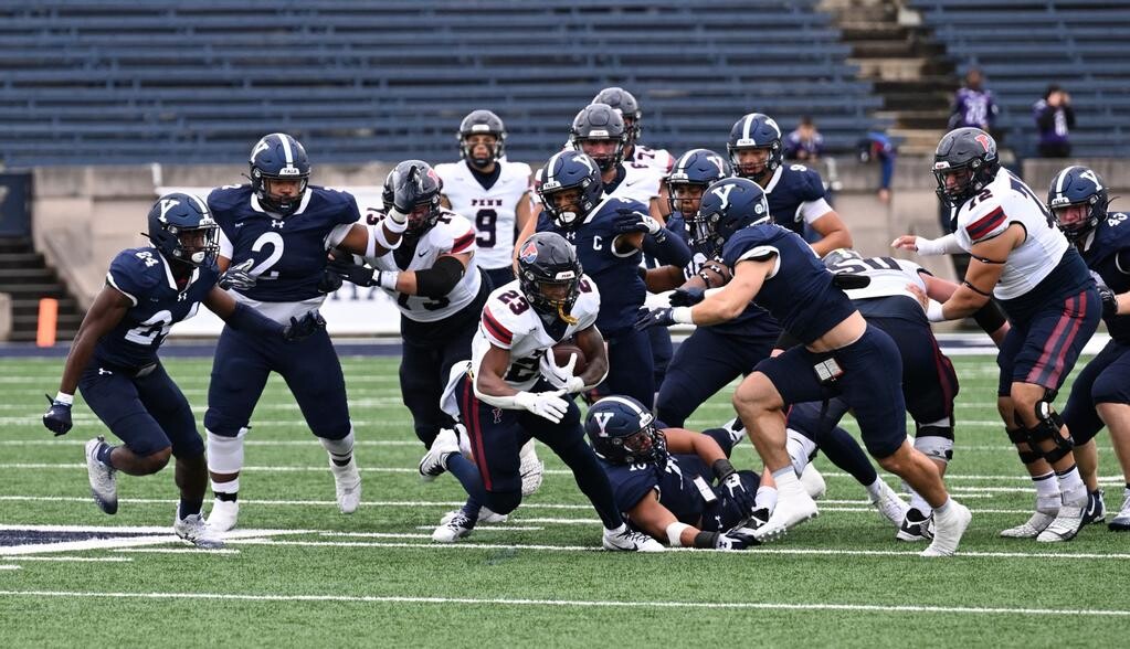 Malachi Hosley runs the ball up the middle against Yale.