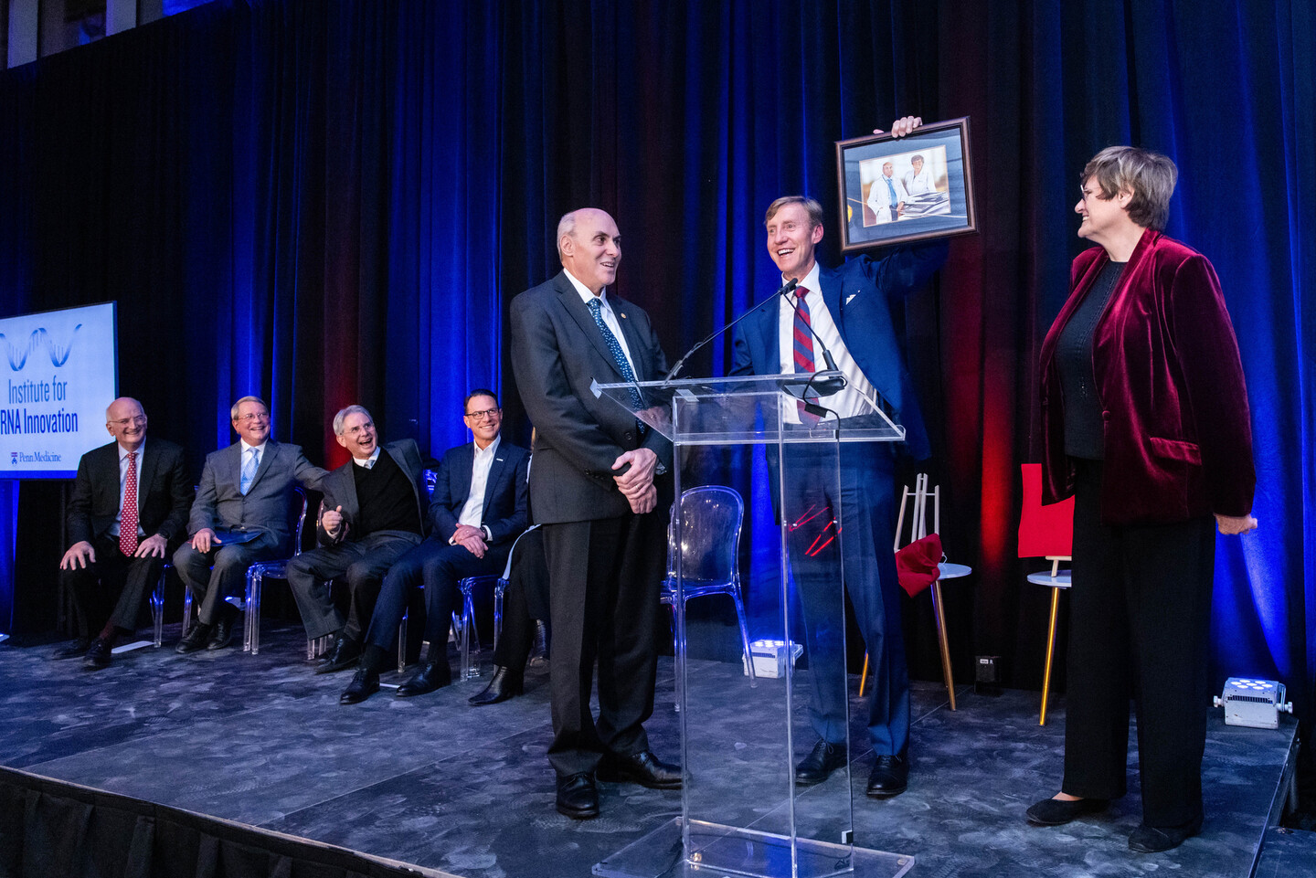 dean jameson presents a photo to weissman and kariko
