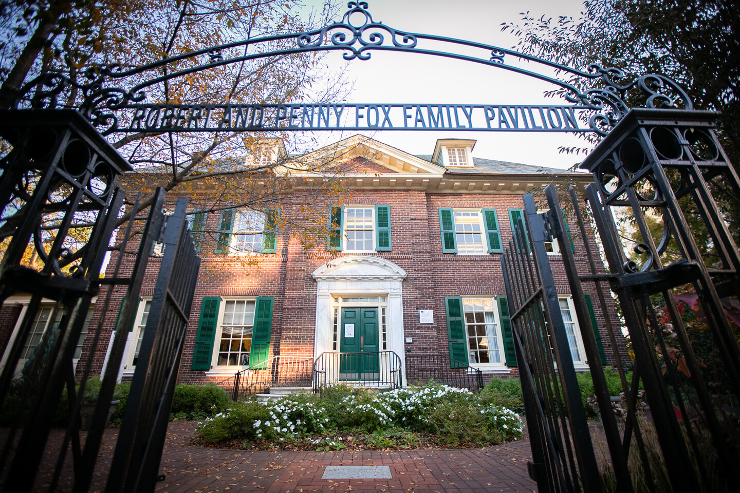 Front of red brick Fox-Fels building with green shutters and white trimon Penn Campus