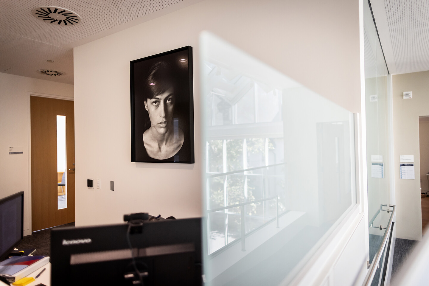 desk area with artwork on wall behind desk