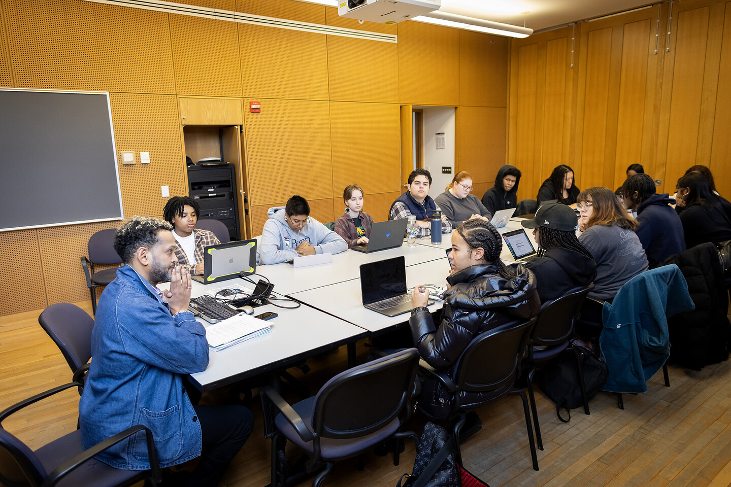 Students and Professor Woubshet gathered around a classroom seminar table.