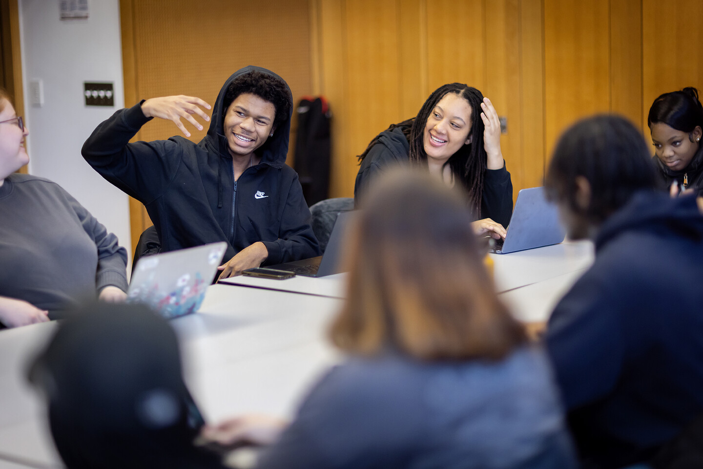 Students animatedly participating in class. 