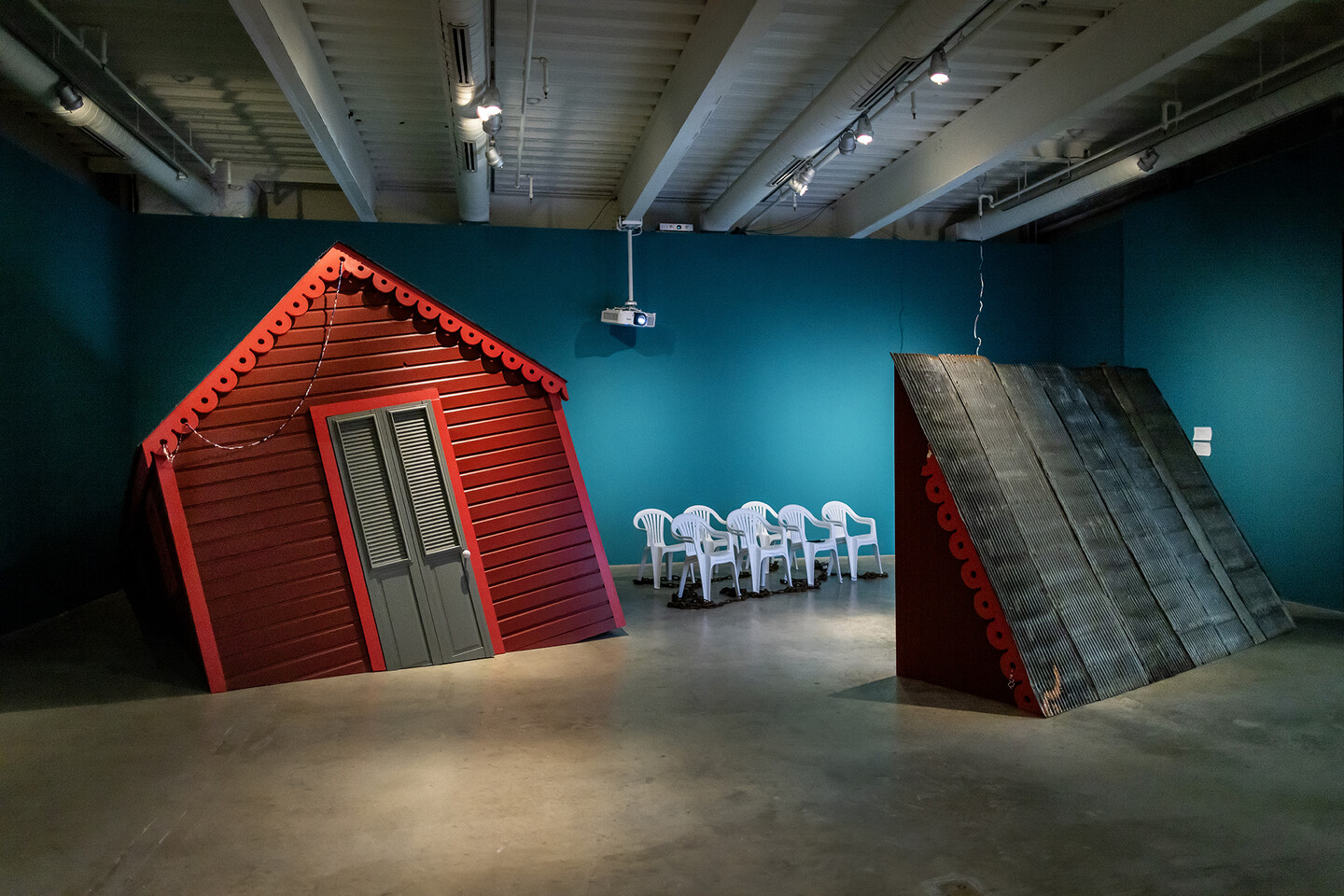 Red marooned house in an art gallery.