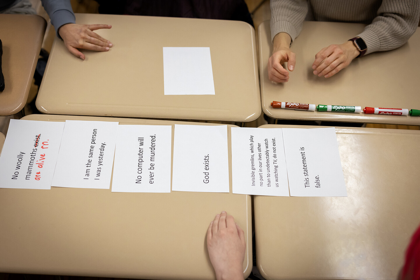 Statements laid out on table for Philosophy Club activity.