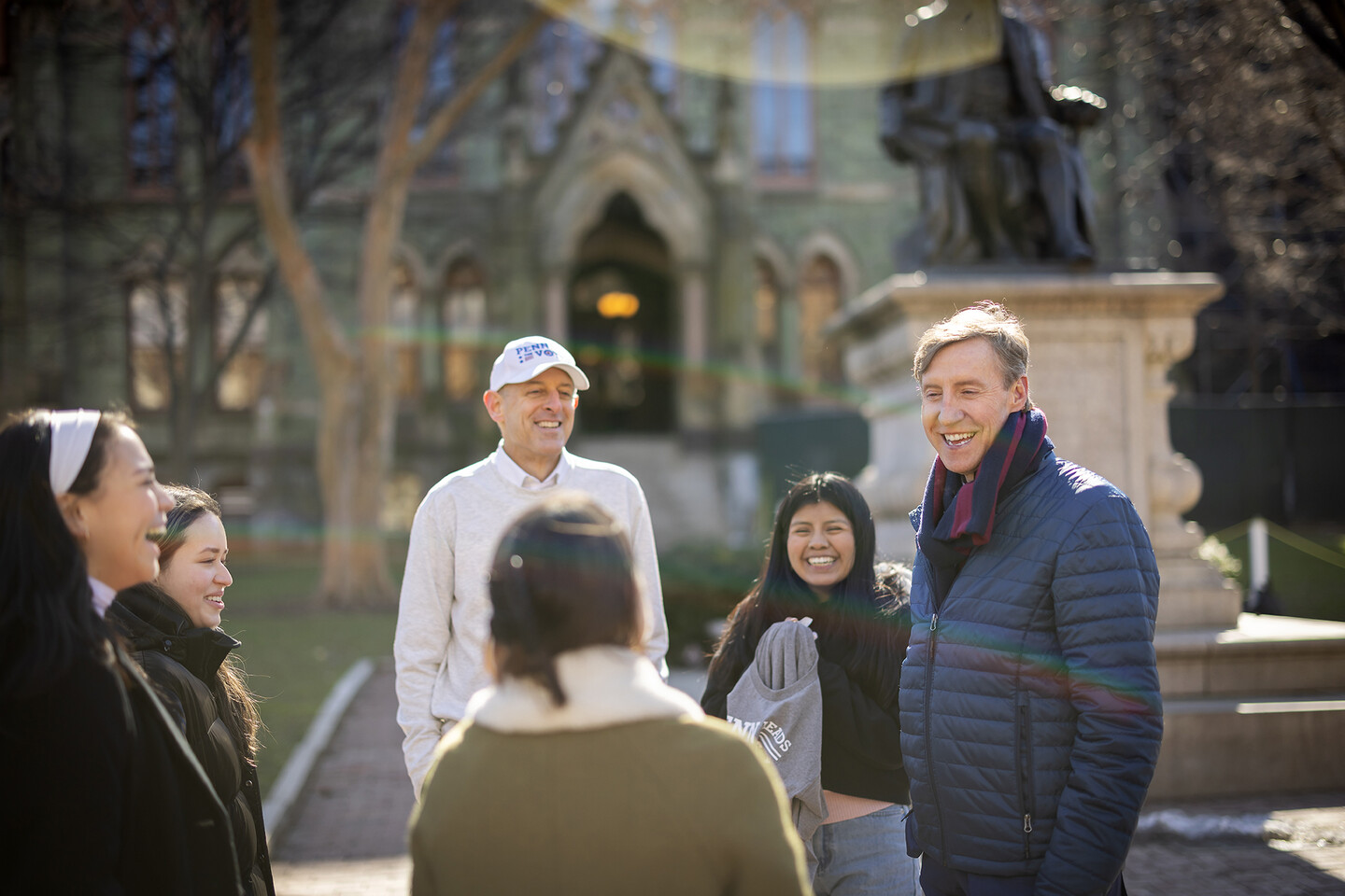 Group of people chatting on College Green.