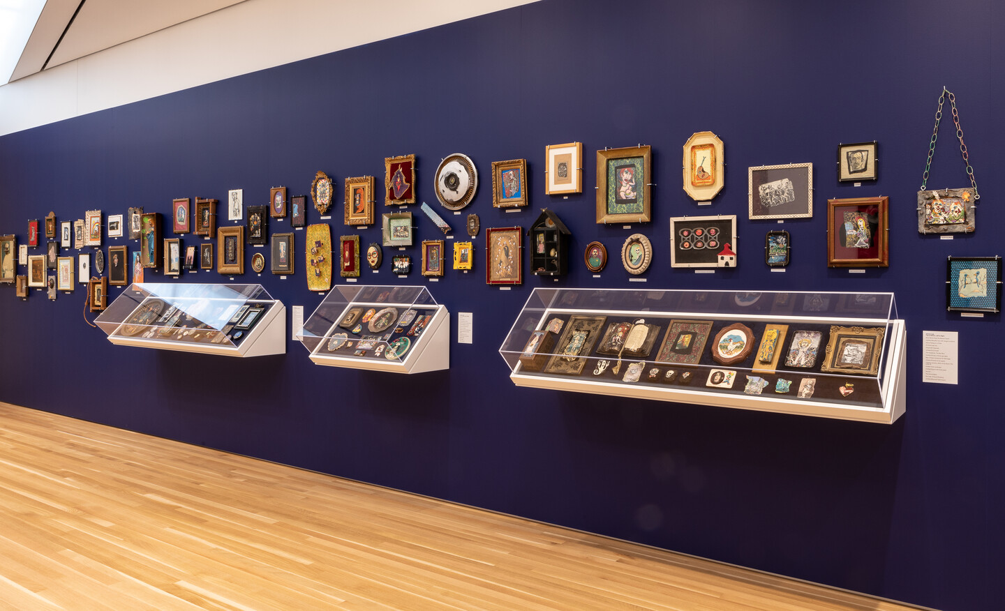 A long blue gallery wall hung with pictures