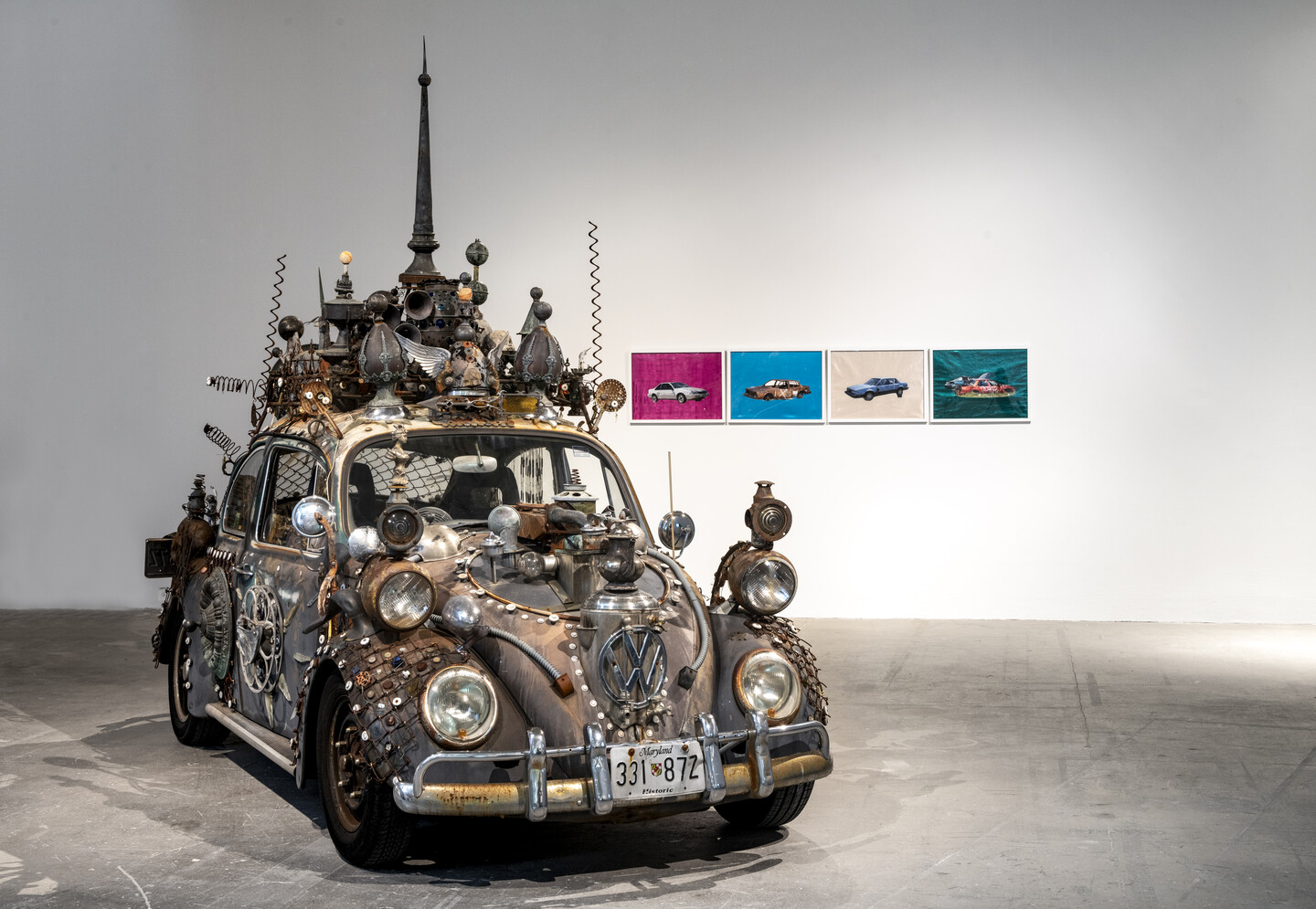 Salvaged car adorned with miscellaneous objects.