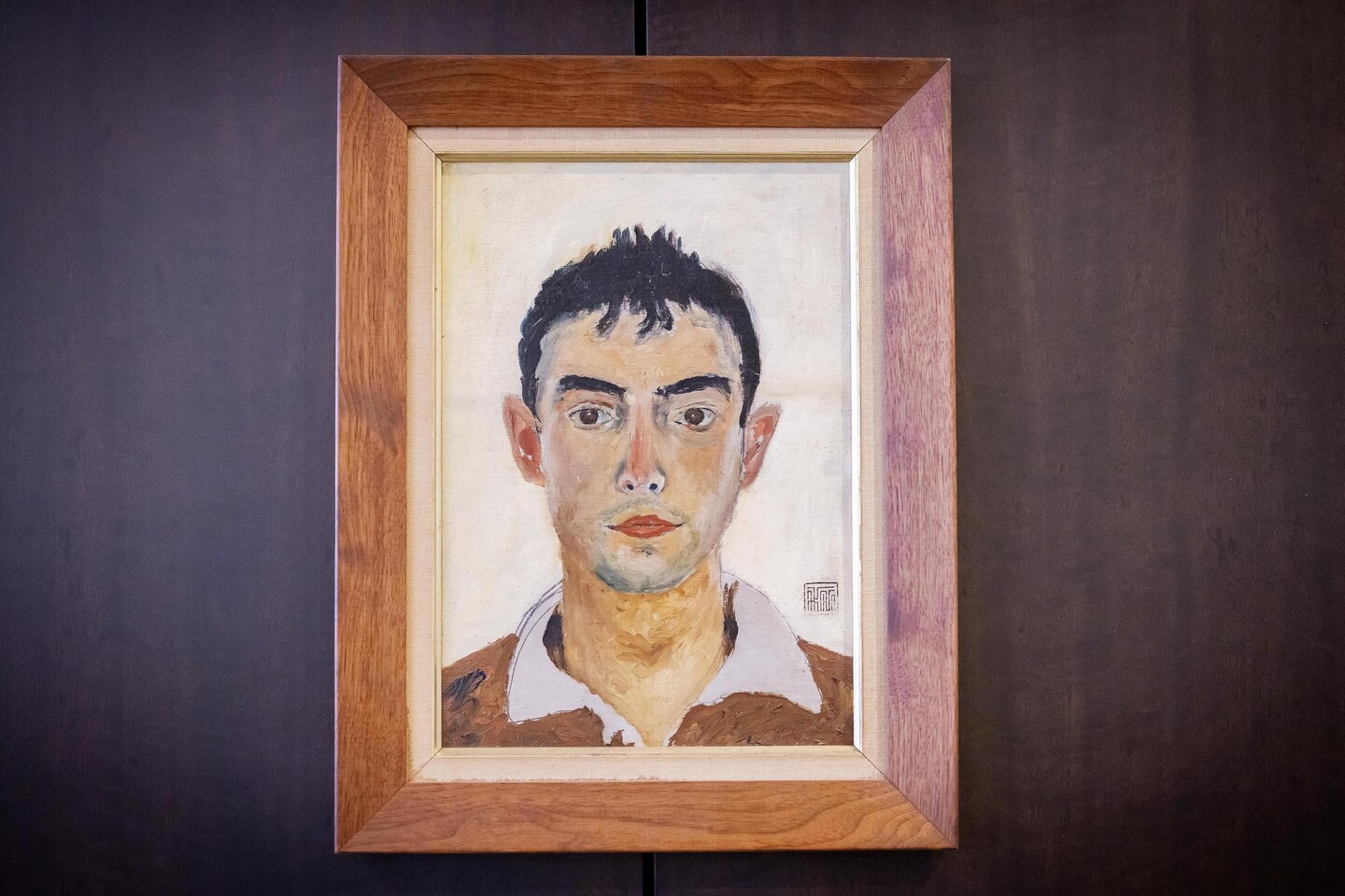 A self-portrait of William Carlos Williams in a wooden frame