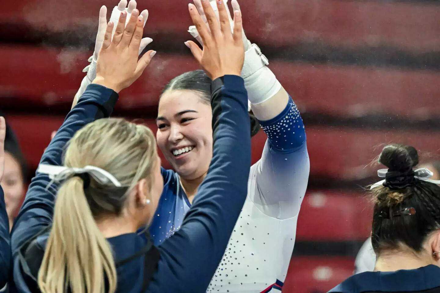 Carly Oniki celebrates with teammates during a competition.