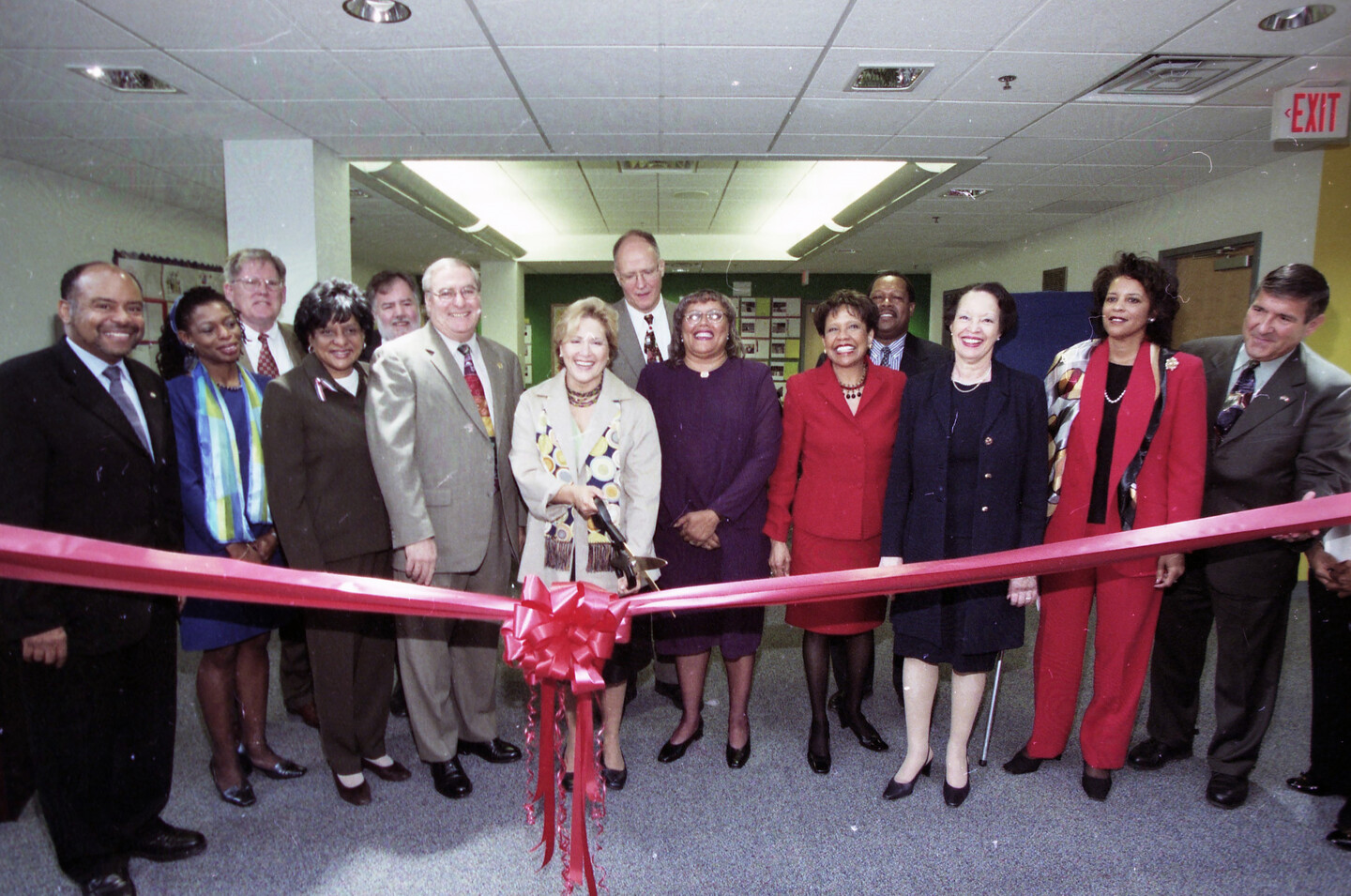 Judith Rodin cutting the ribbon to Penn Alexander School in West Philadelphia. She is surrounded by local teachers, policymakers, and school administrators.