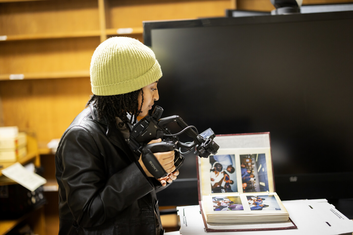 Hosaena Tilahun takes video of photo album.