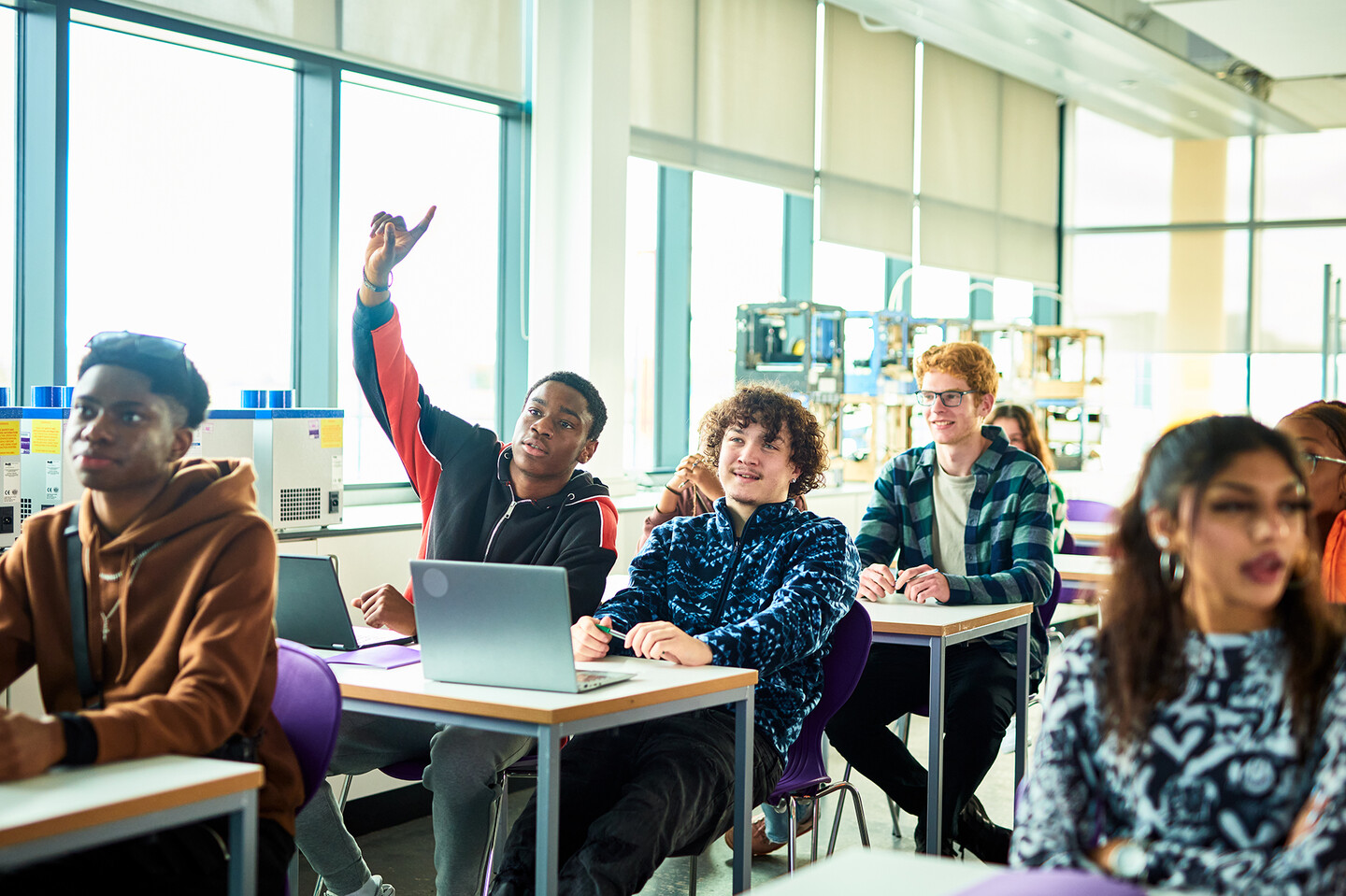 A high school classroom with kids in class at their desks.
