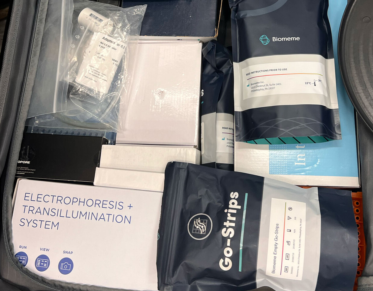 Portable lab equipment and reagents packed into a suitcase.