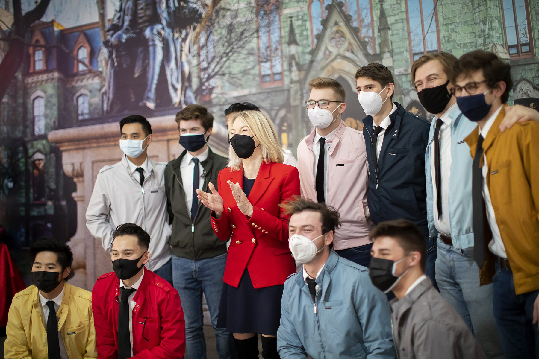 Penn President Amy Gutmann smiles for the camera with a group of Penn students.