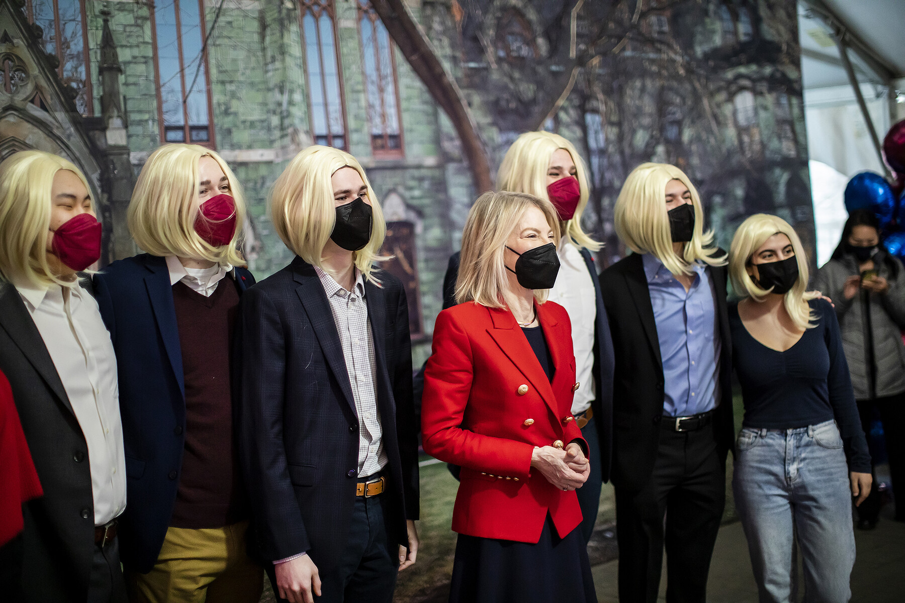 Penn President Amy Gutmann smiling for a photo with a group of students.