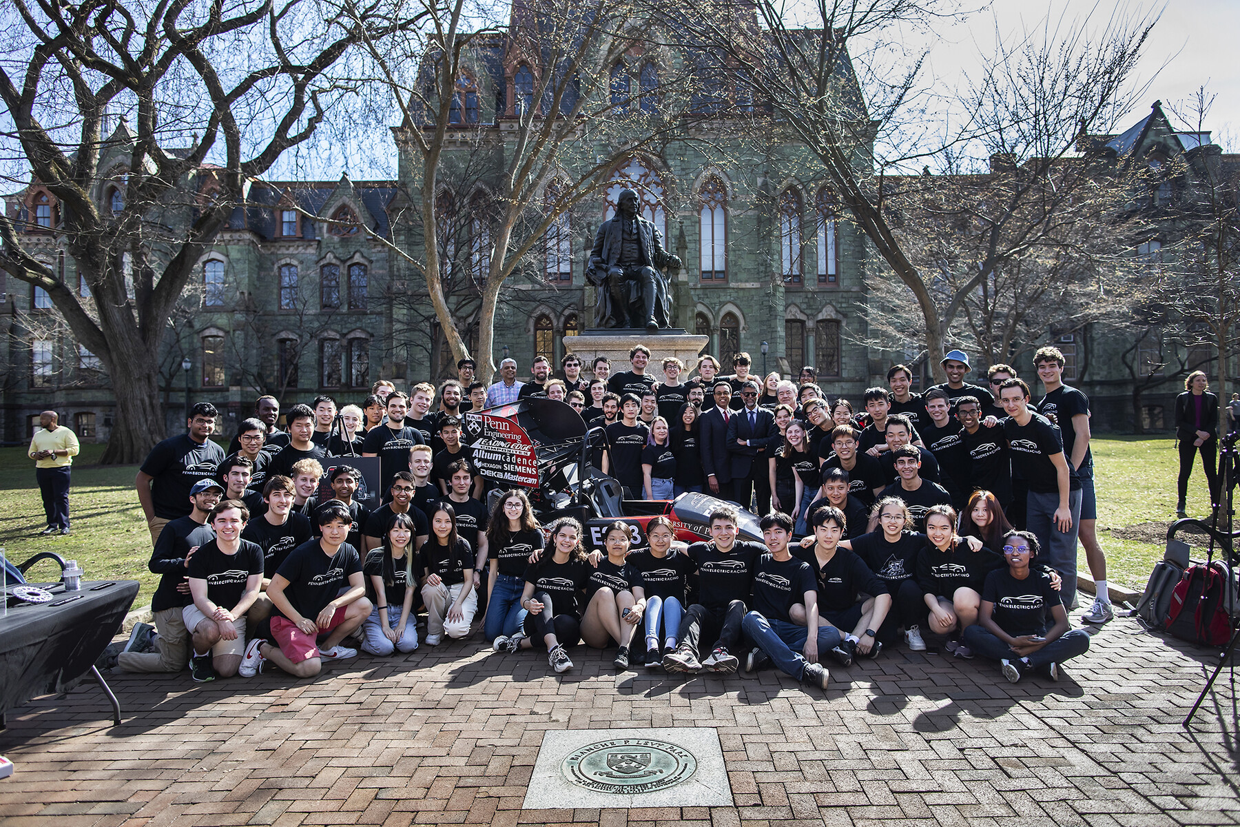 Members of Penn Electric Racing pose as a group in front of College Hall with Interim President Wendell Pritchett.