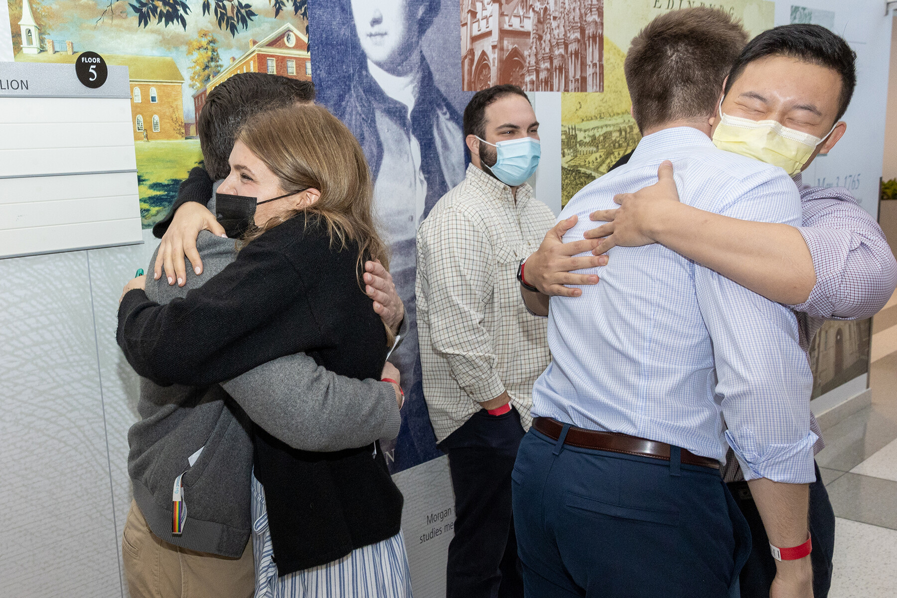 Two couples hug on Match Day.