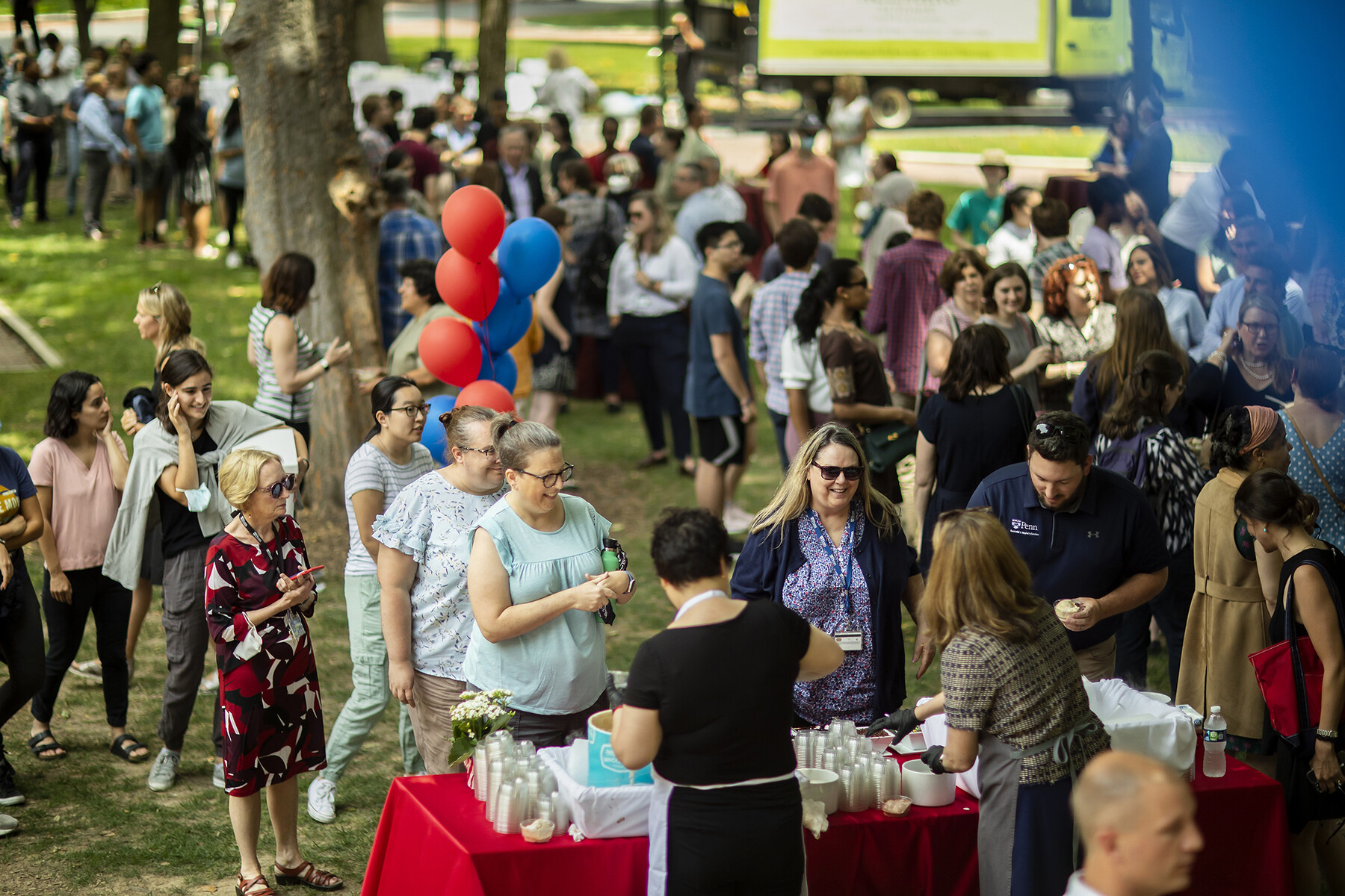 A crowd queues for ice cream on College Green with Liz Magill.