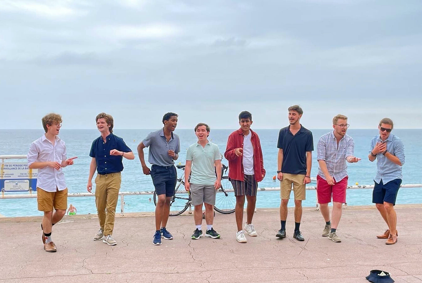Members of the Penn Pipers busking on a beach.