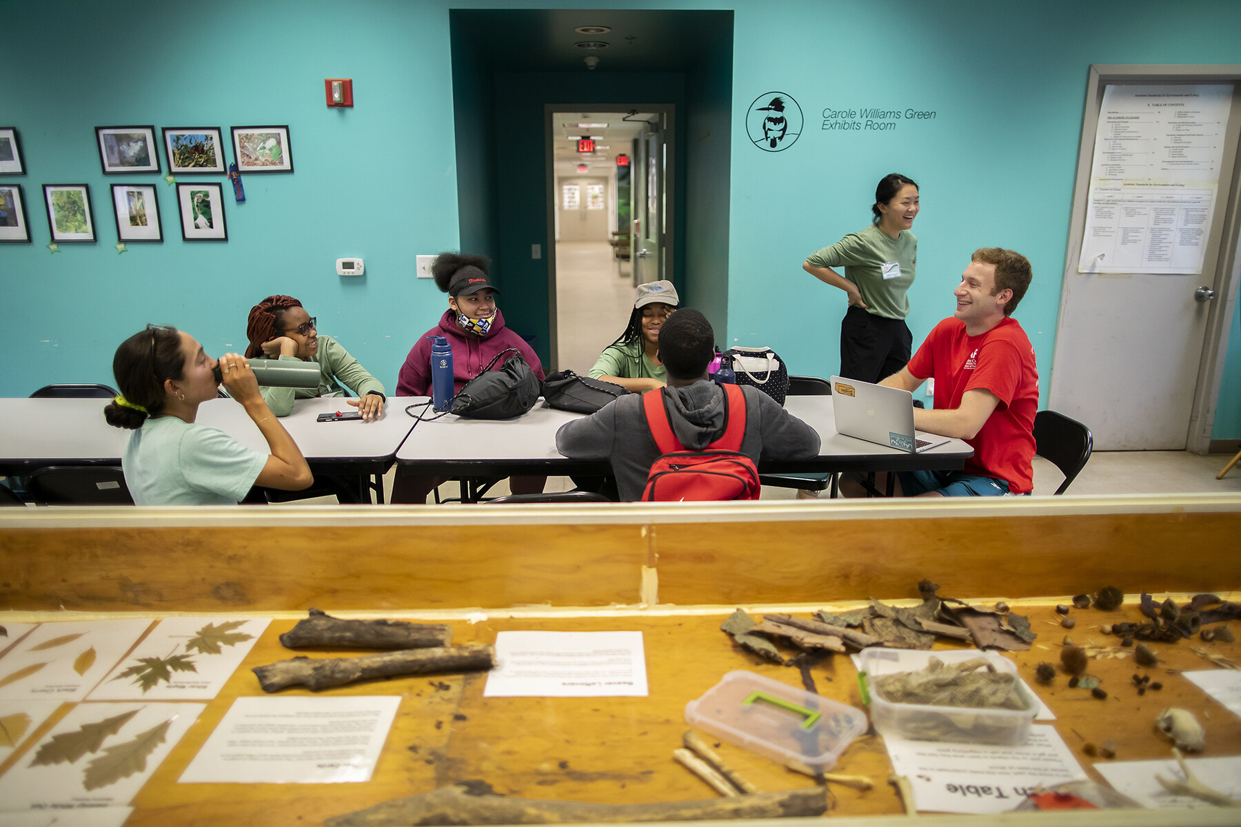 A group of students at a table in Cobbs Creek.