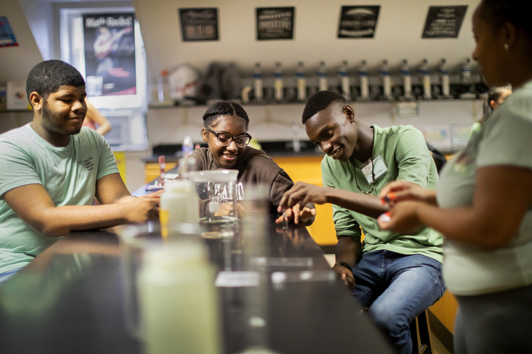 Four students at a lab table working on a group project.