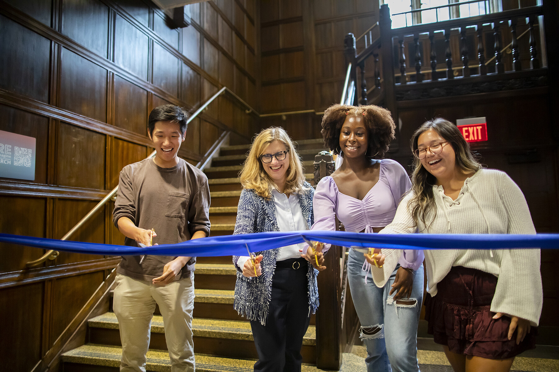 Liz Magill and three others cut a ribbon at the ARCH ribbon cutting.