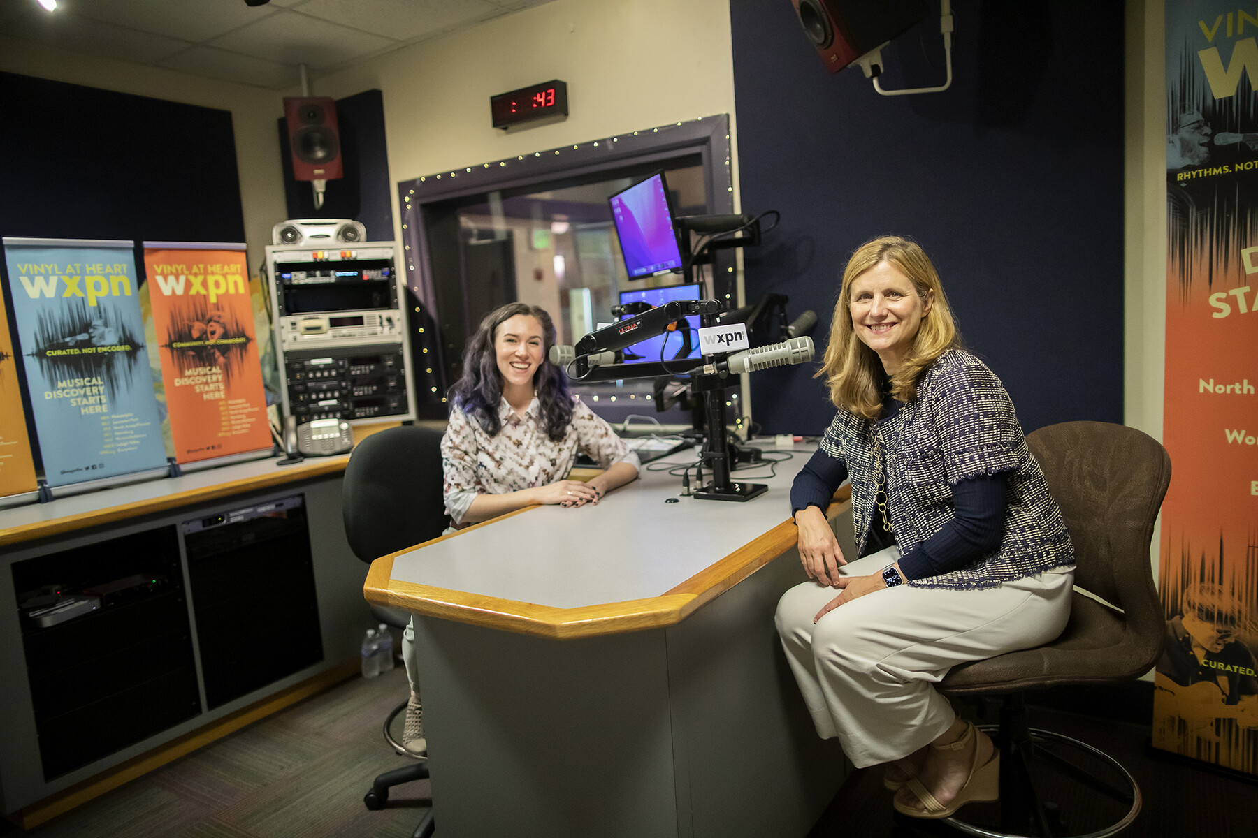 Liz Magill and a DJ with WXPN at a recording studio.