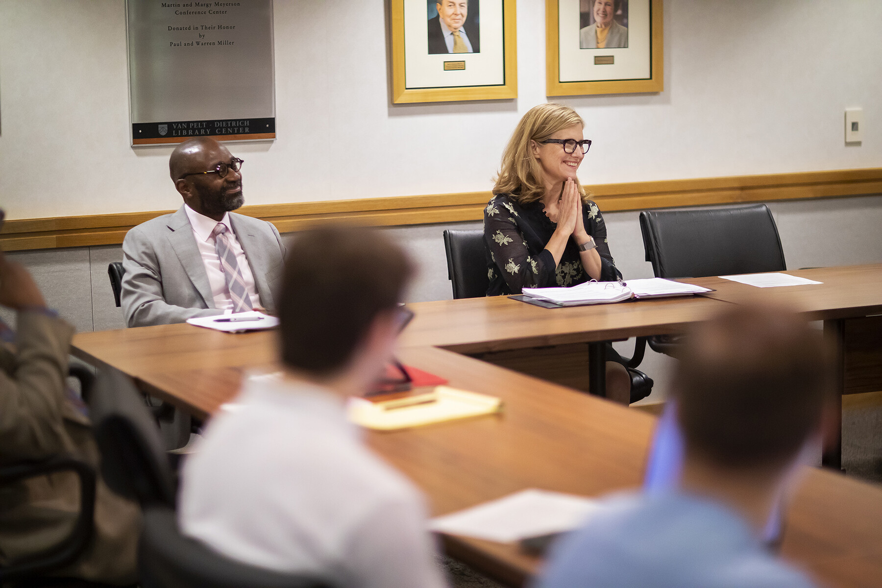Liz Magill at a table as a guest lecturer in a classroom.