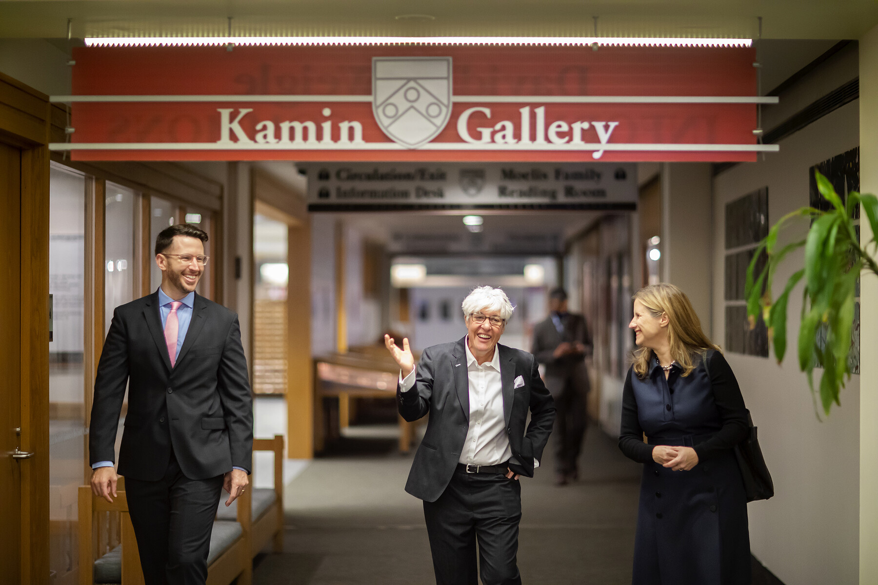 Liz Magill, Constantia Constantinou, and a third person walking in Van Pelt Library.