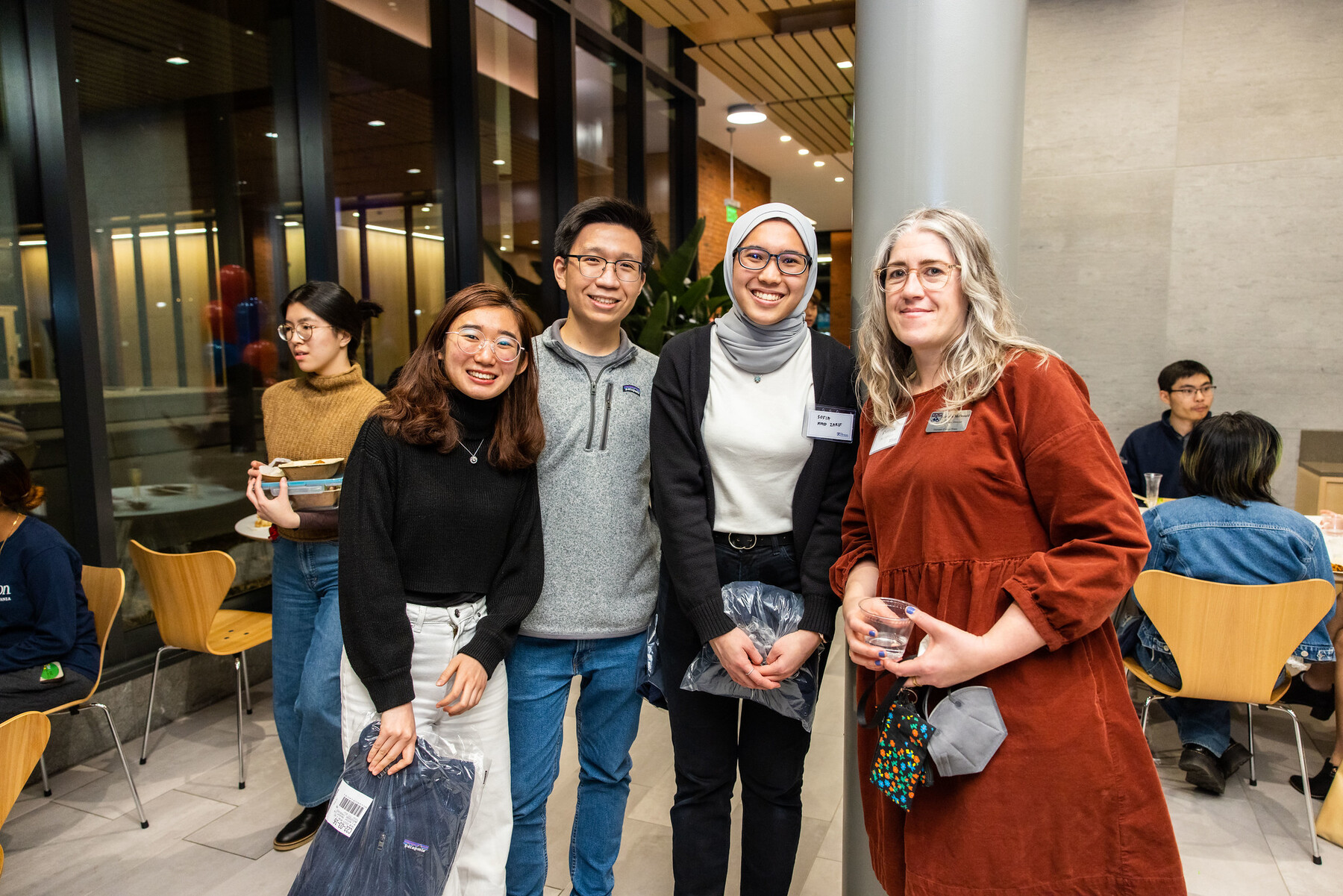 People smile at Gutmann College House reception