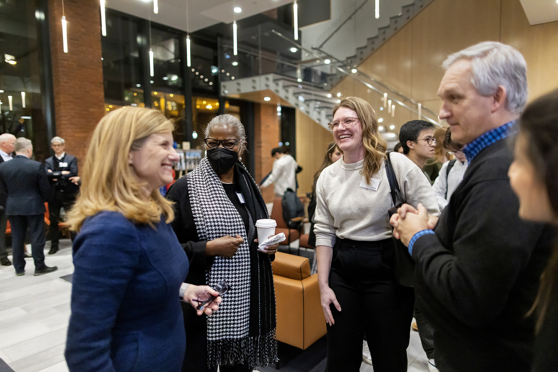 Magill at event, speaking with others