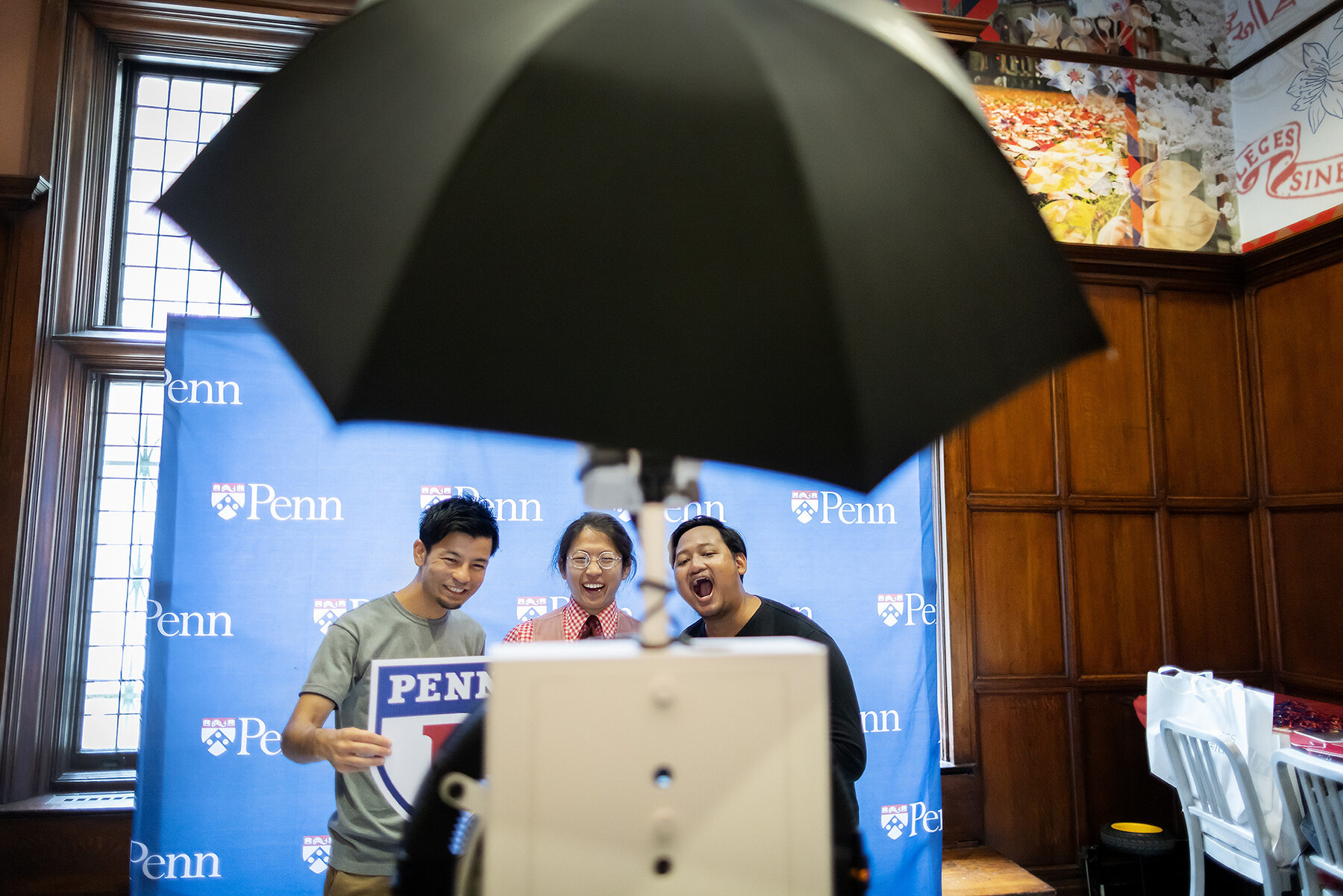 Three students smiling in photo booth