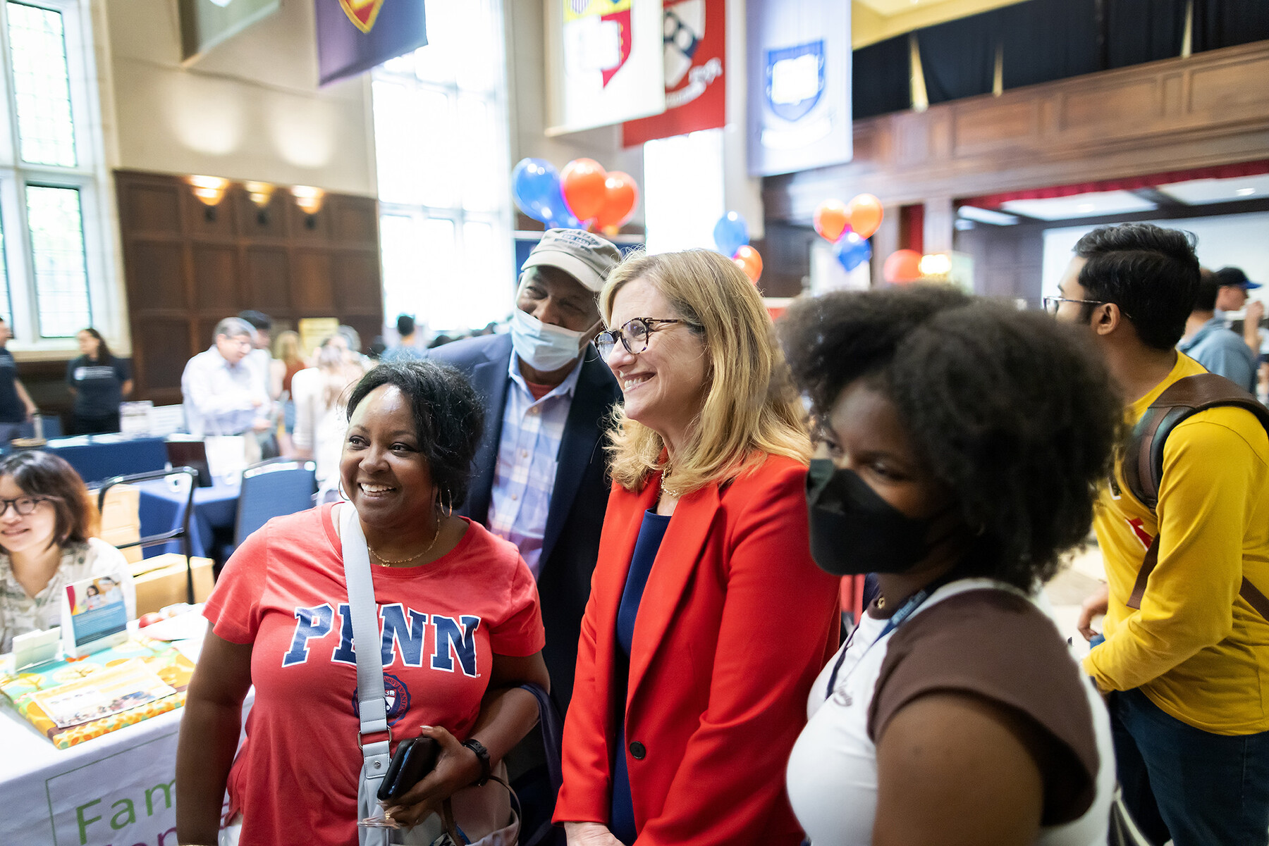 Liz Magill poses with two students at the resource fair