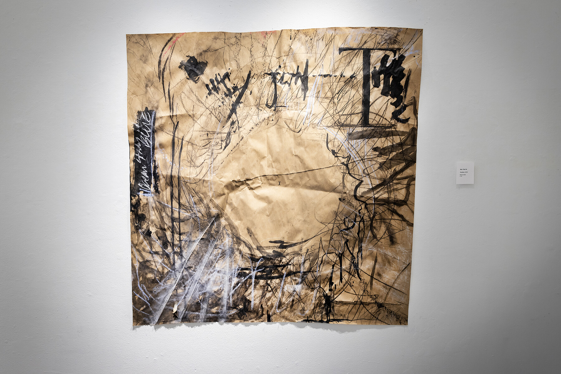 artwork with blank circle surrounded by dark marks