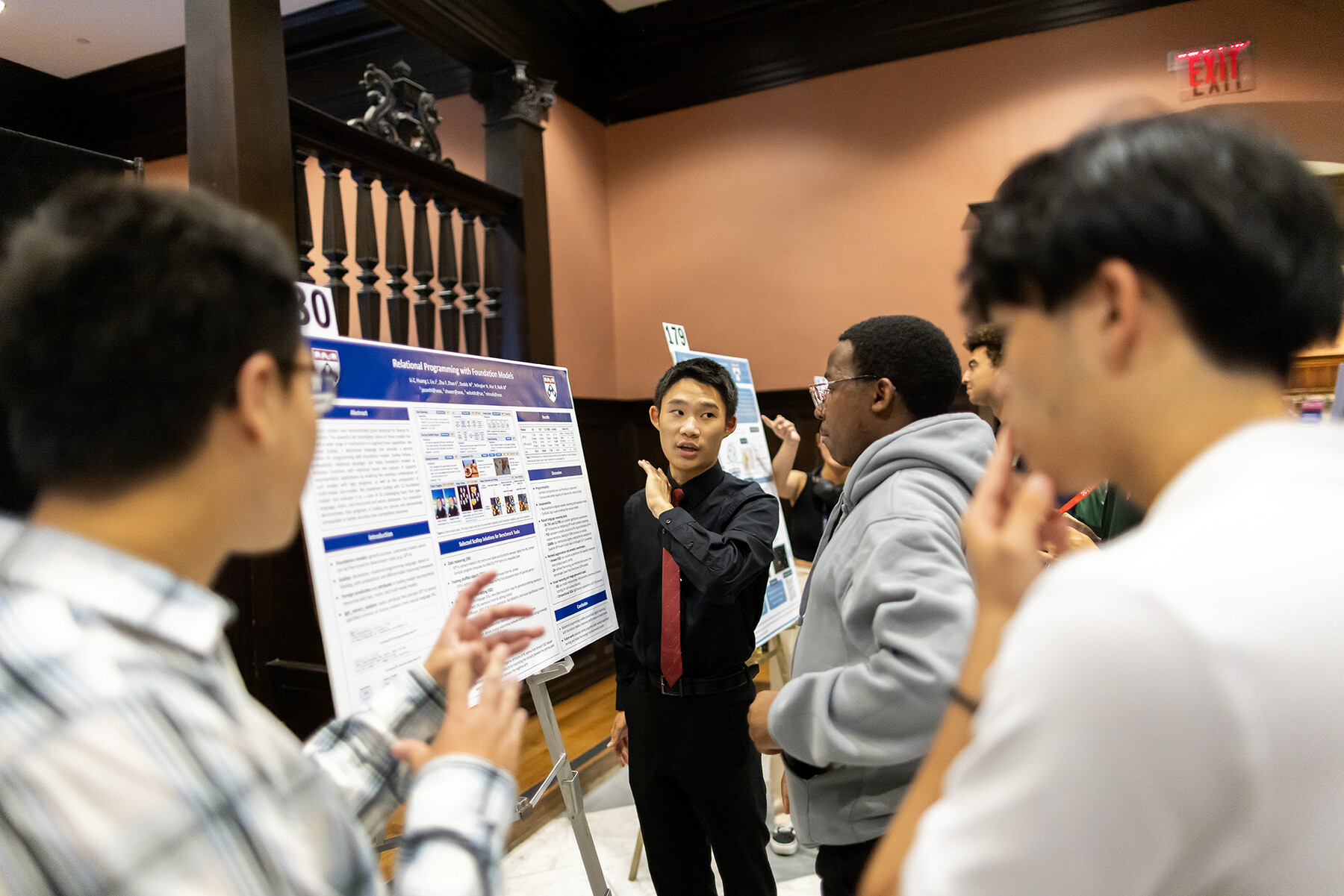 A student discusses their poster with others at the CURF poster expo.