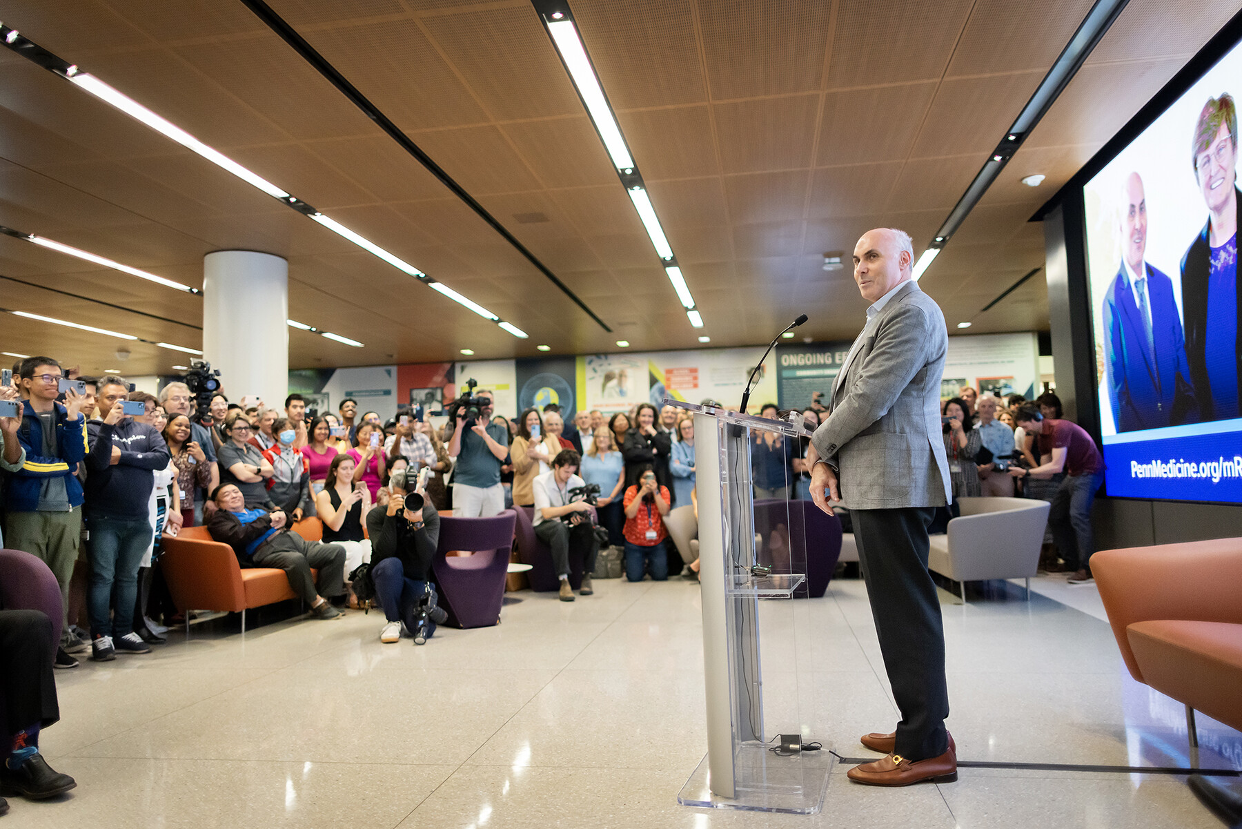 Drew Weissman at the podium addressing the crowd at the Penn Medicine flash mob.