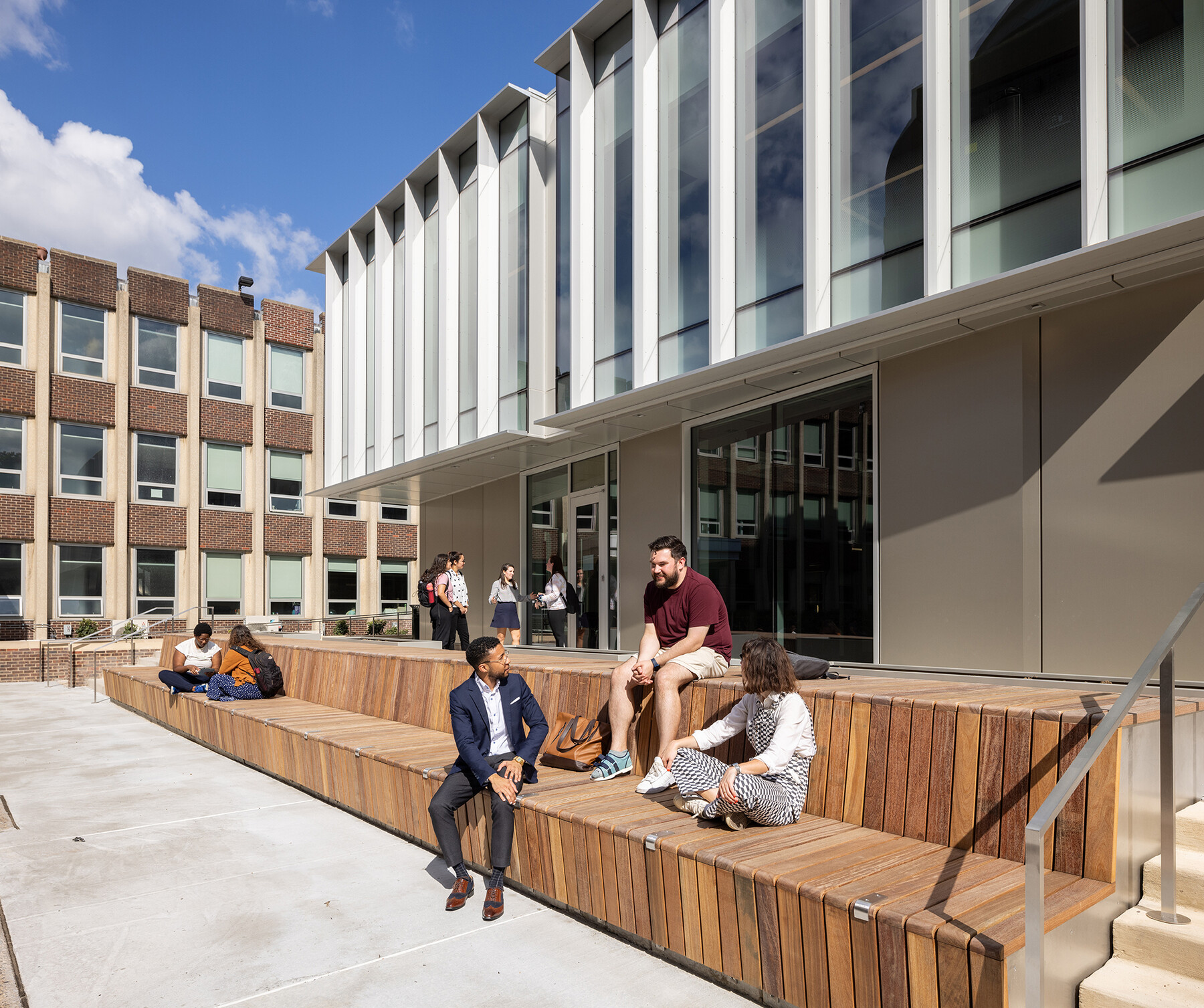 People seated outside the Penn GSE building.
