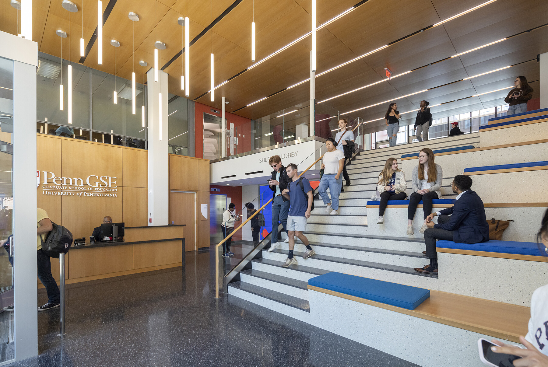 People on the stairs and in the lobby of the Penn GSE building.