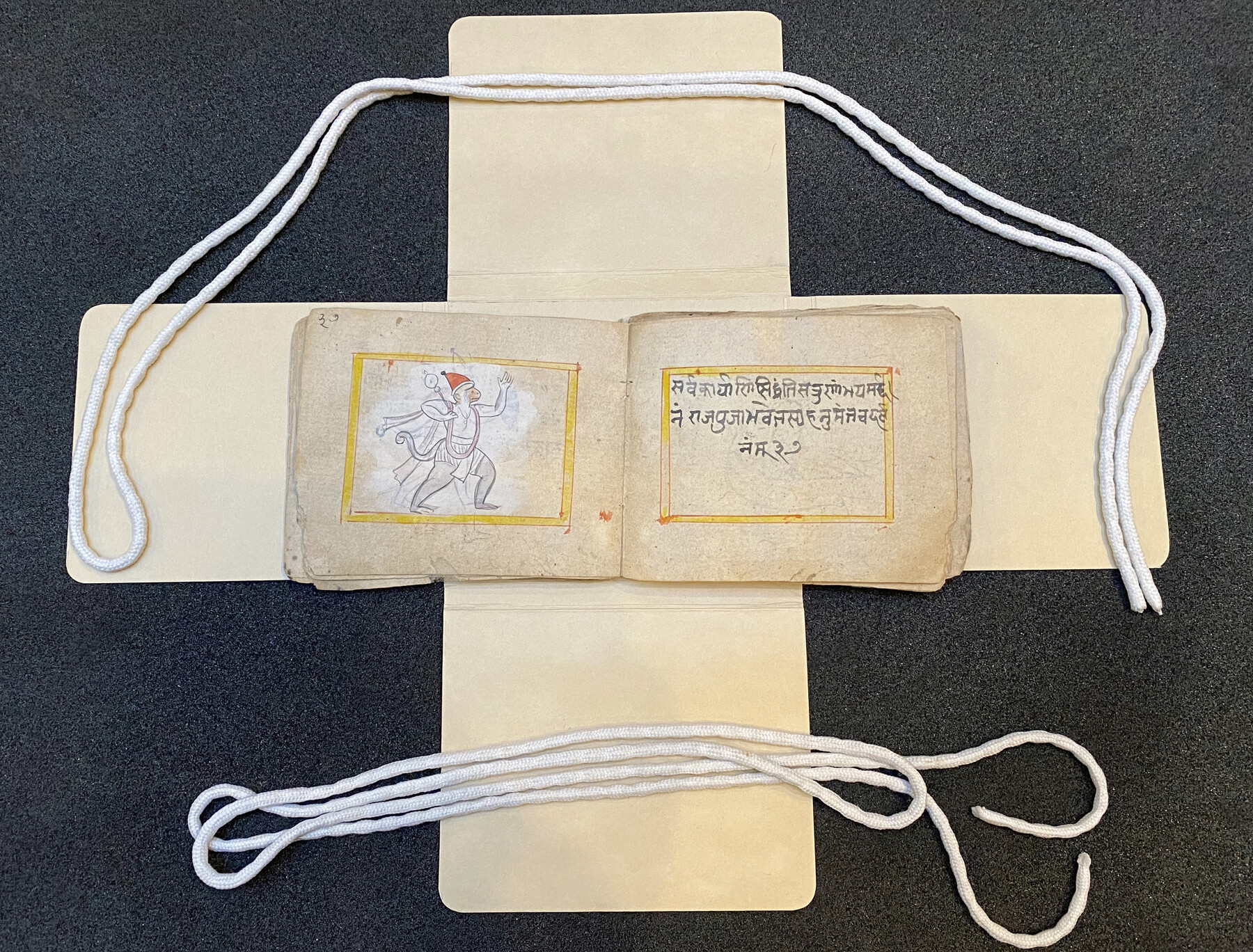 Ancient hand-drawn Indian text and drawing.