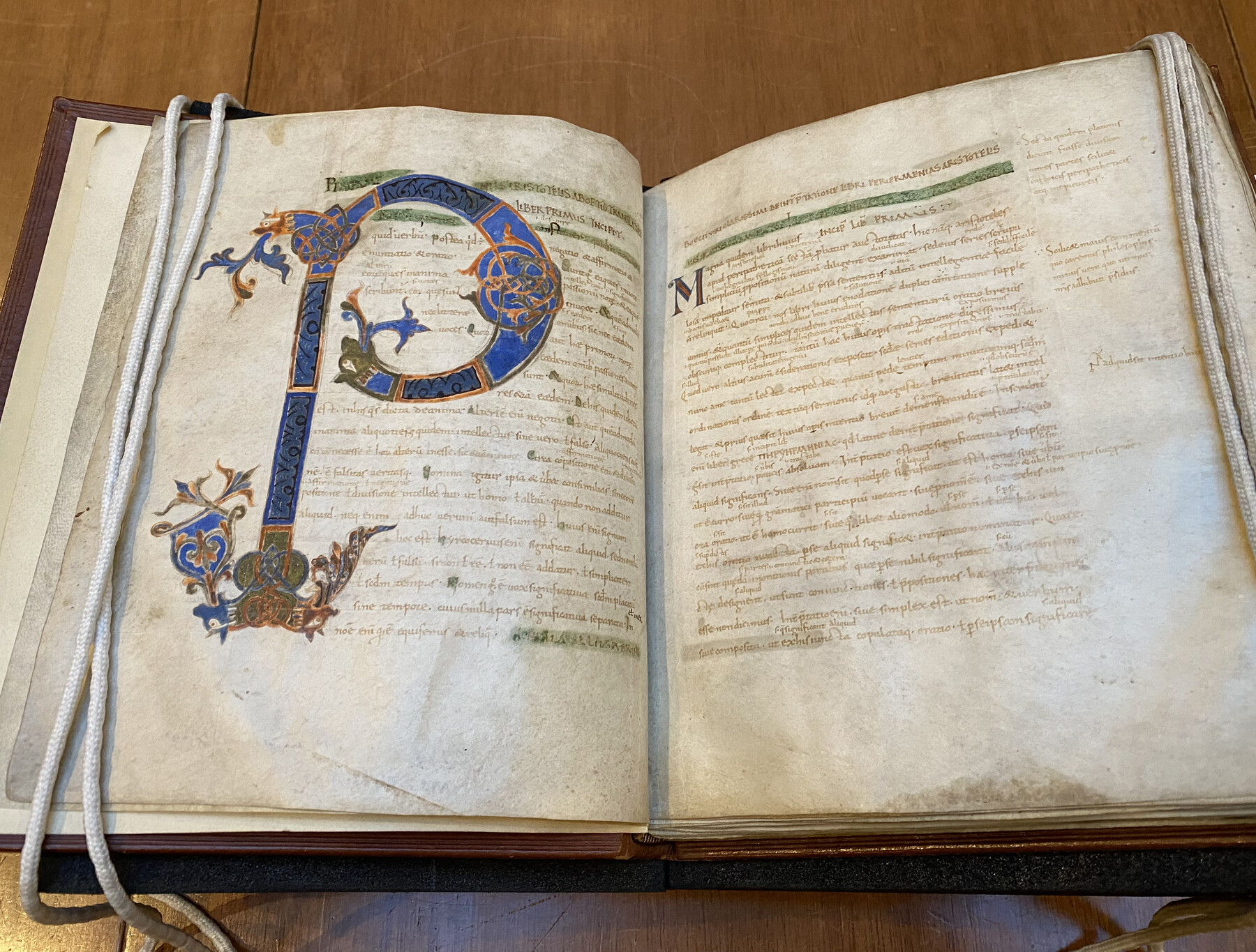 An open ancient book of Aristotle in Latin.