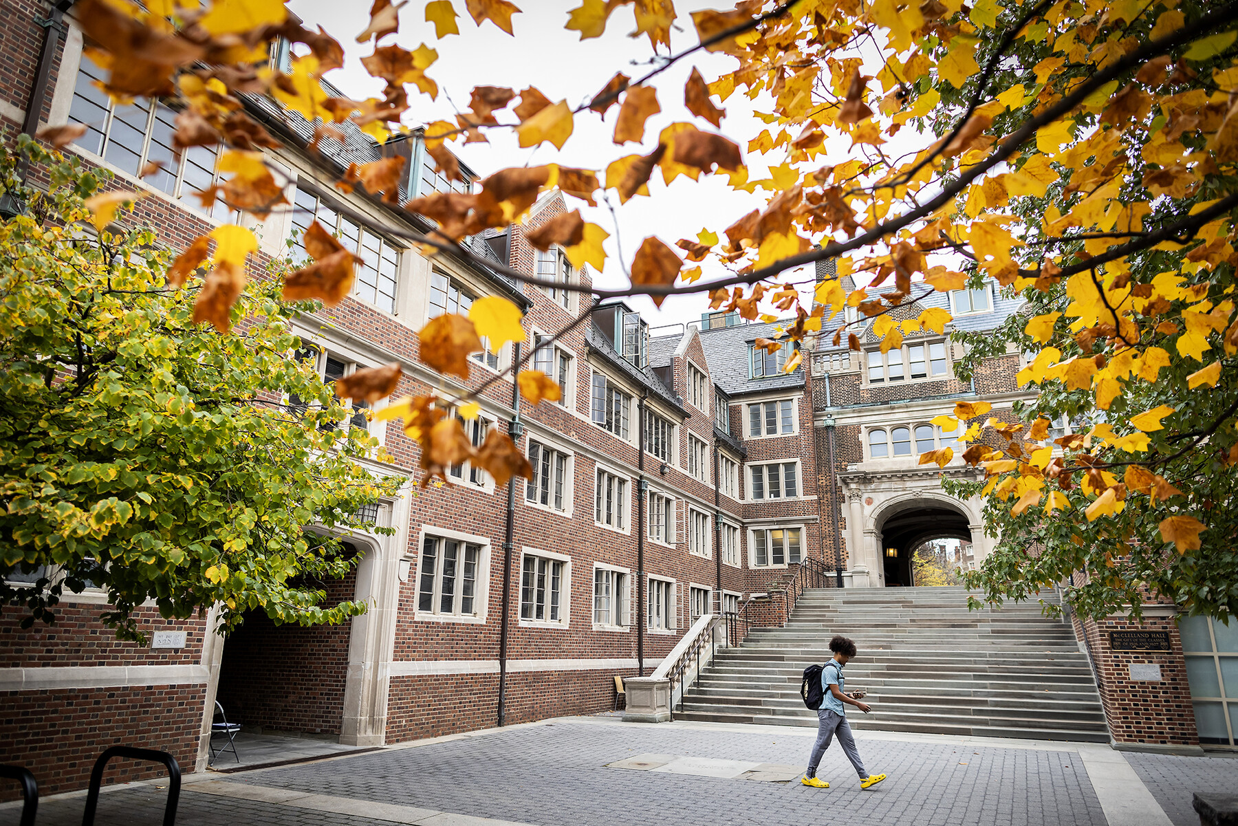 a student walking through the penn quad