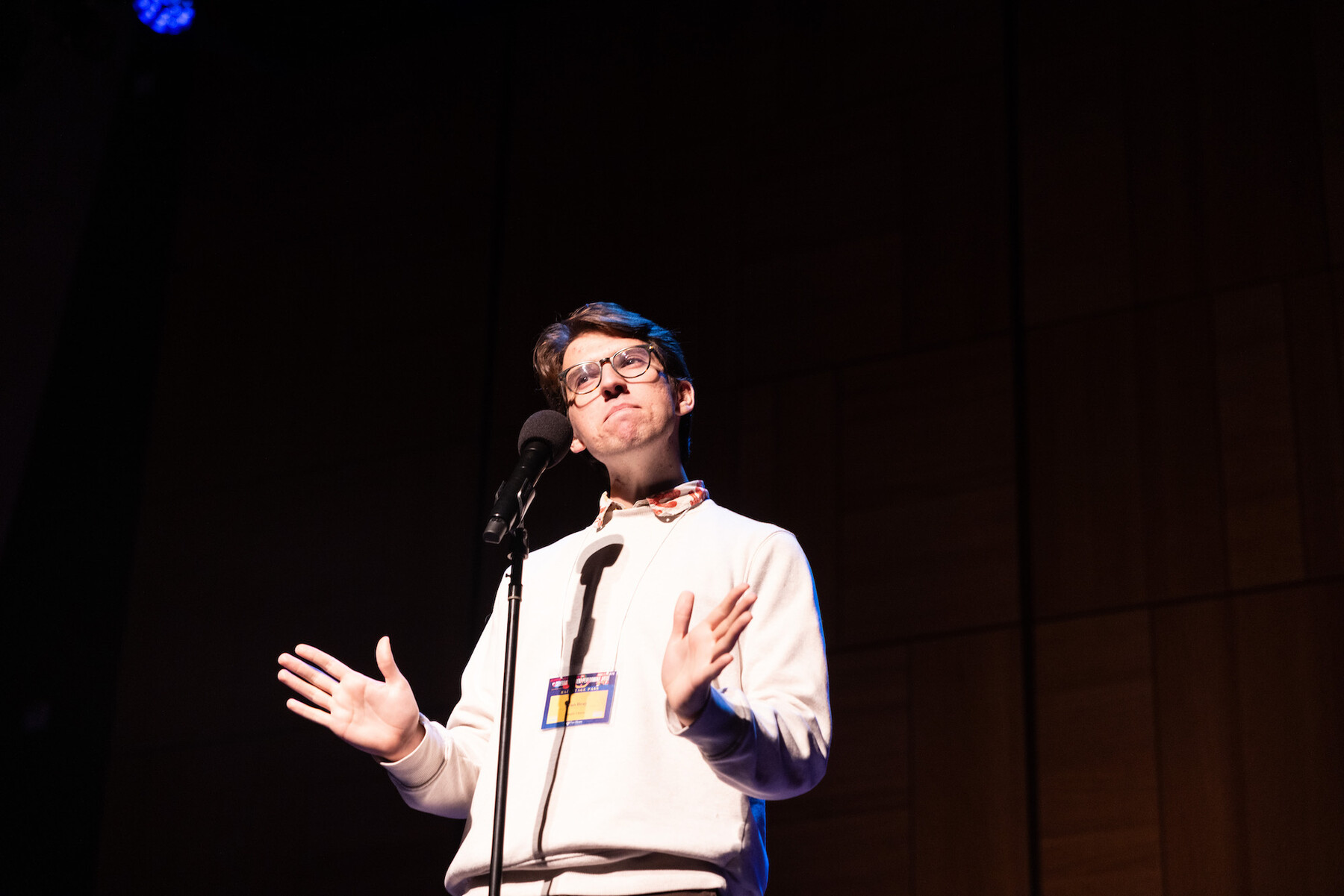 Sean Bray performing stand-up on stage at Carnegie Hall.