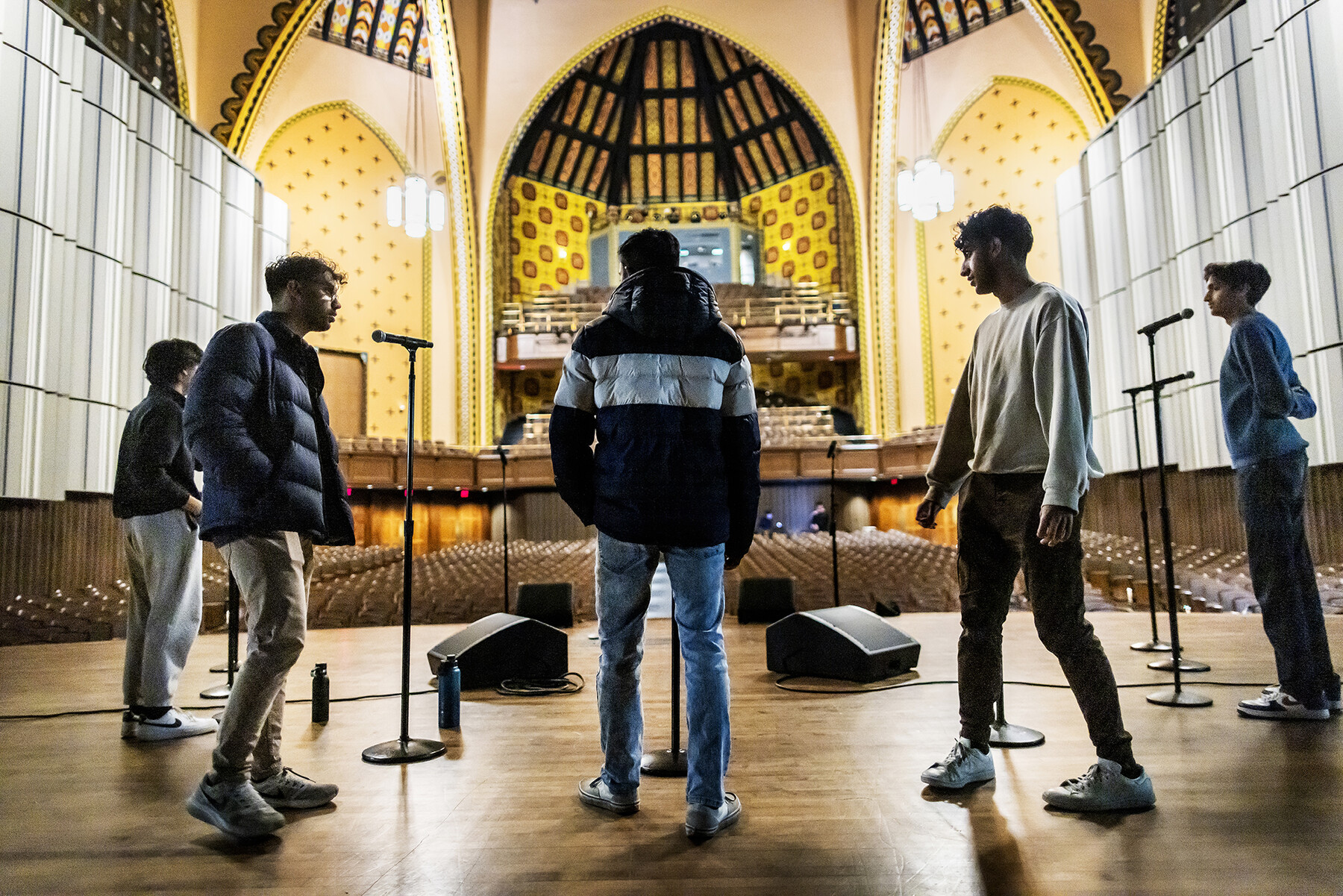Members of a Penn performing arts group in rehearsals on stage.
