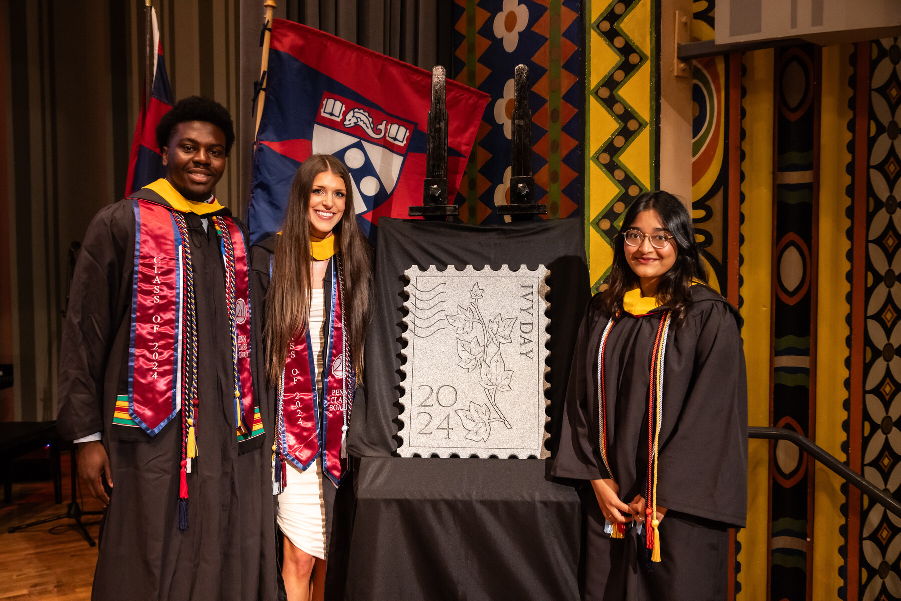 students pose with ivy stone on stage