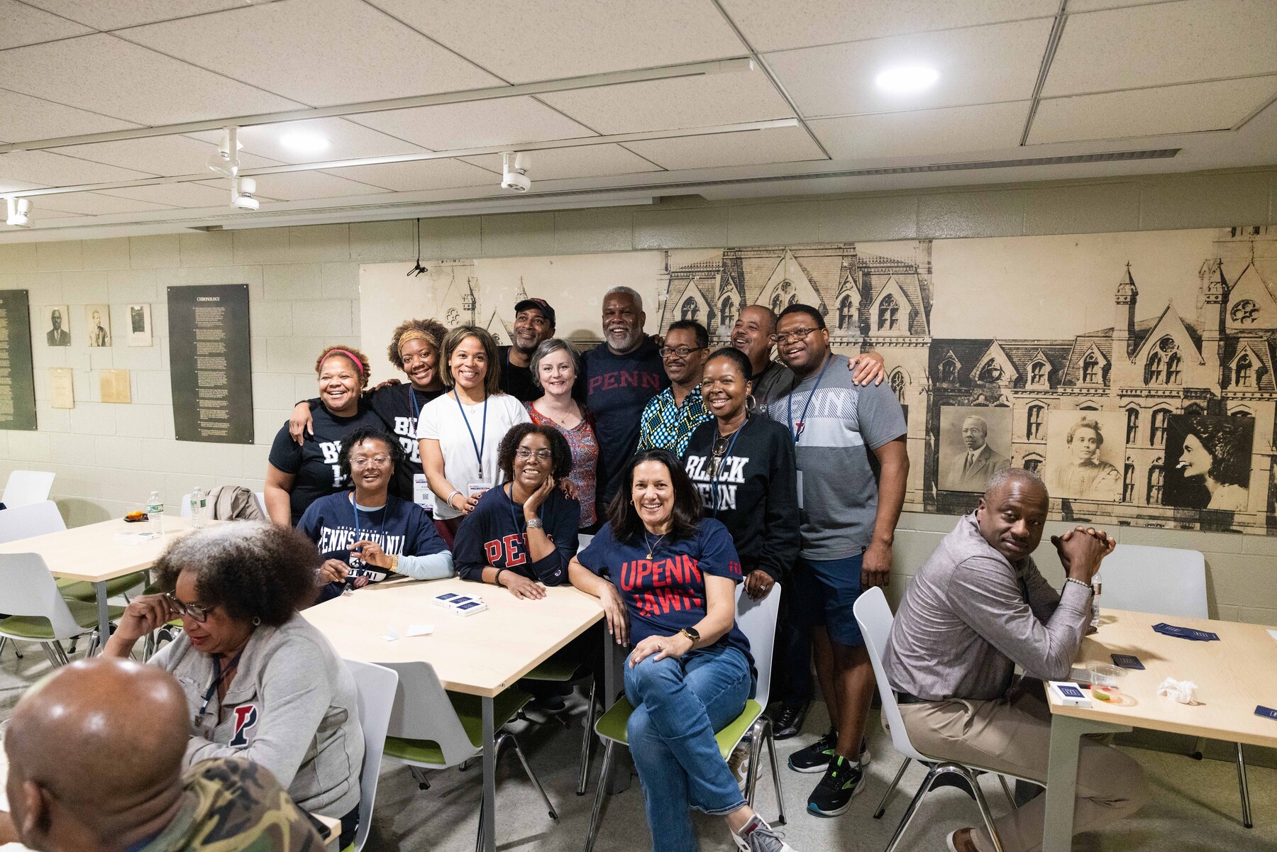 Alumni pose for a photo during a card tournament