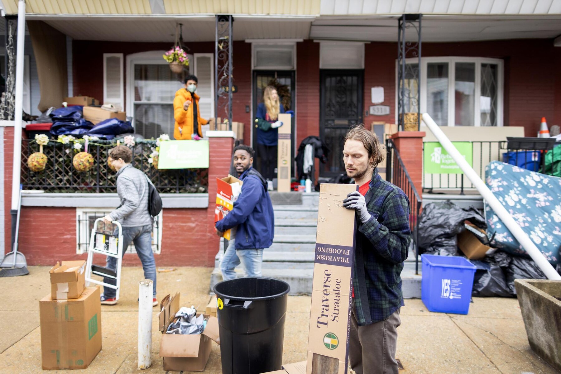 Volunteers carrying boxes and supplies during the block build.