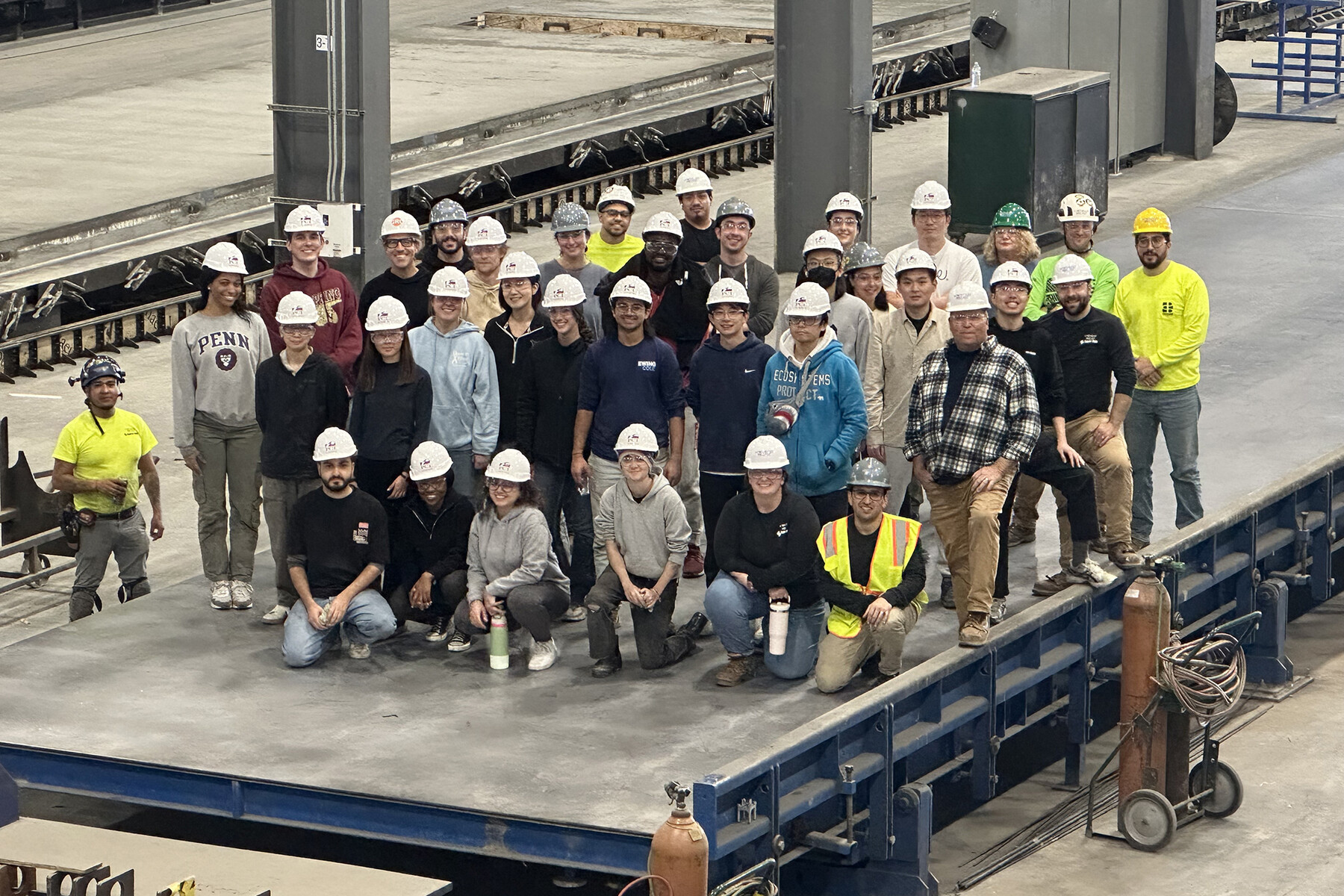 The group of students who worked on constructing the concrete panels pose for a group photo.