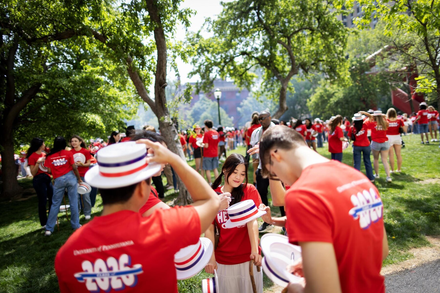 Students signing hats during Penn’s Hey Day.