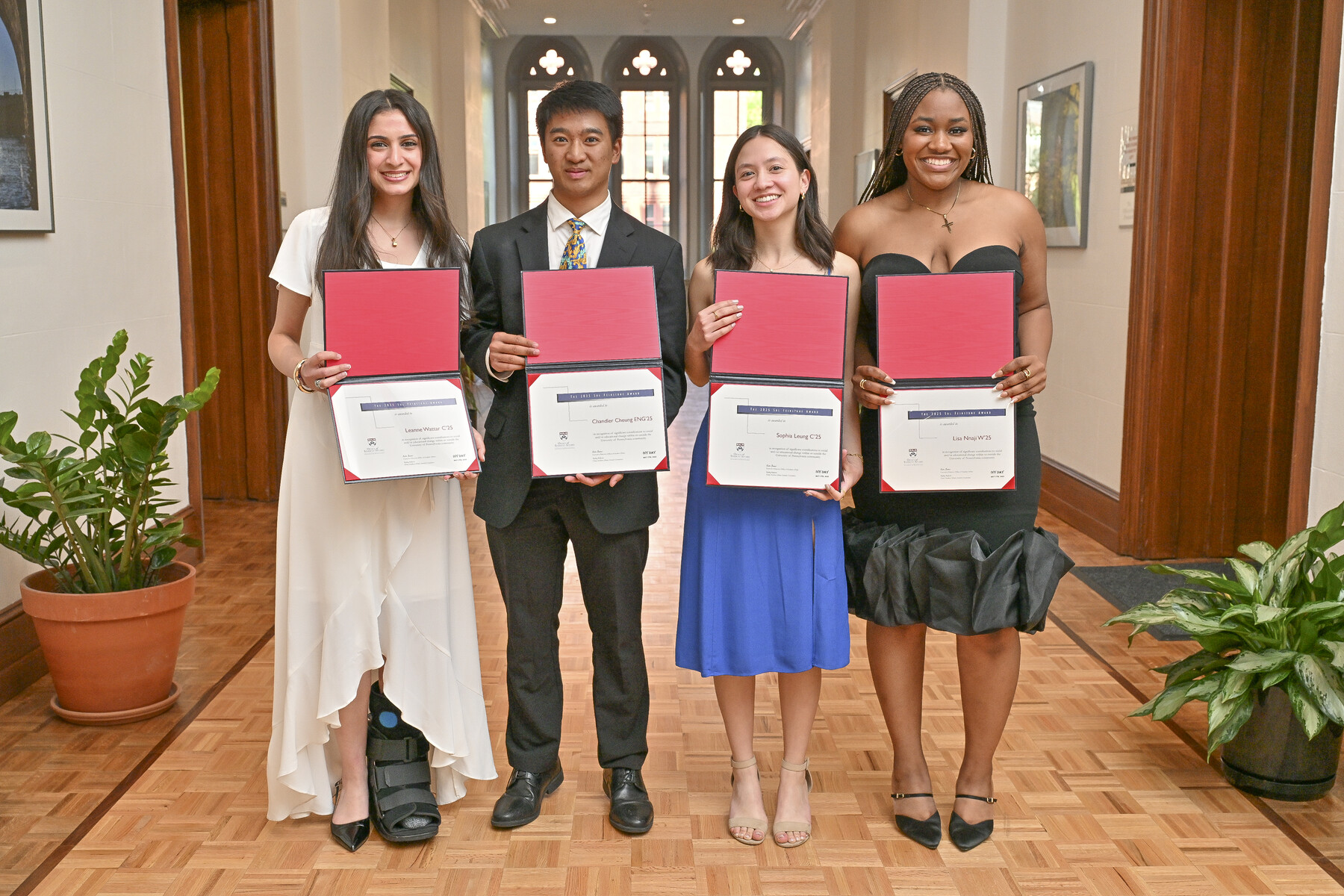 Four award winners holding their awards at the Ivy Day Ceremony.