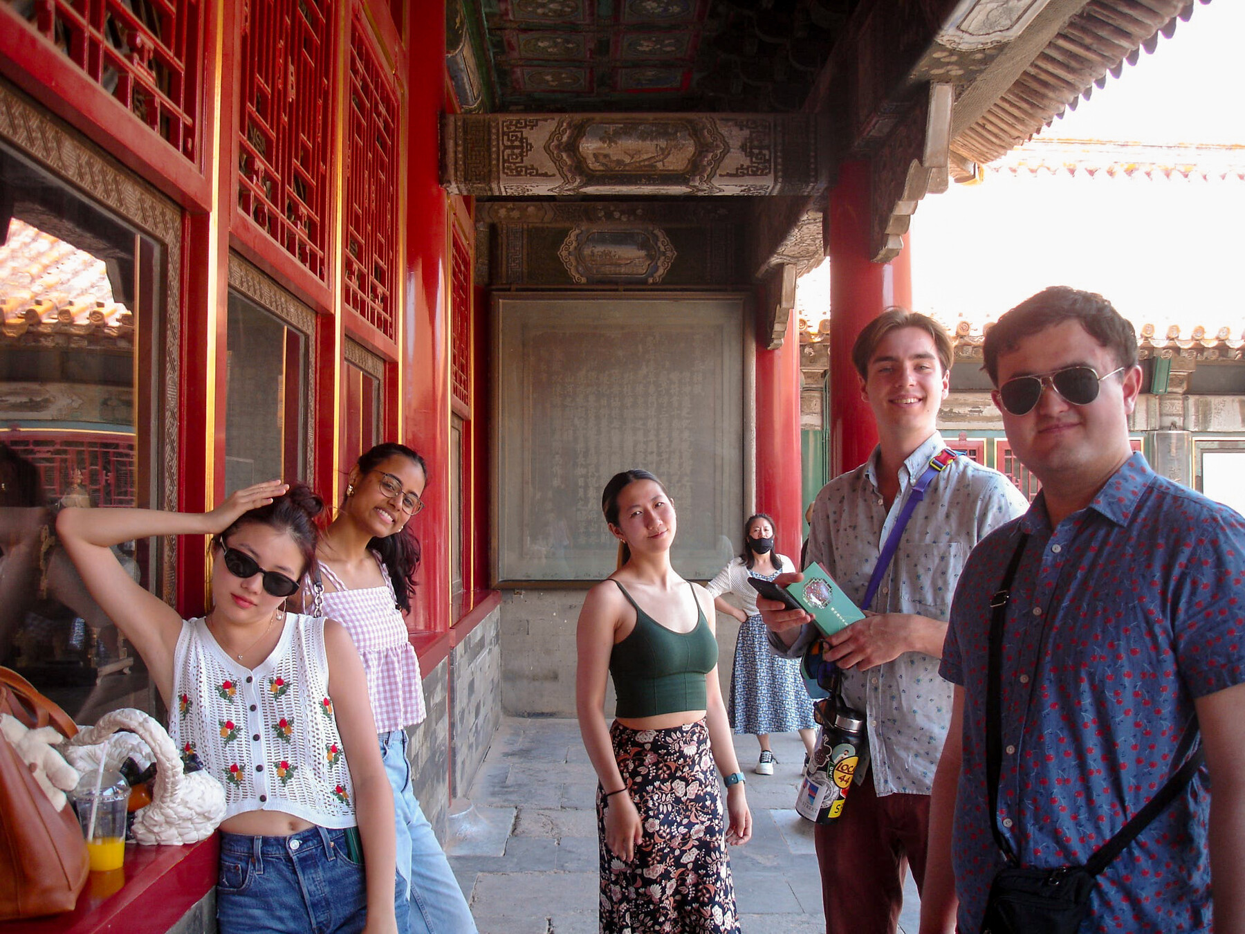 glee club members standing in elaborate pagoda-like building